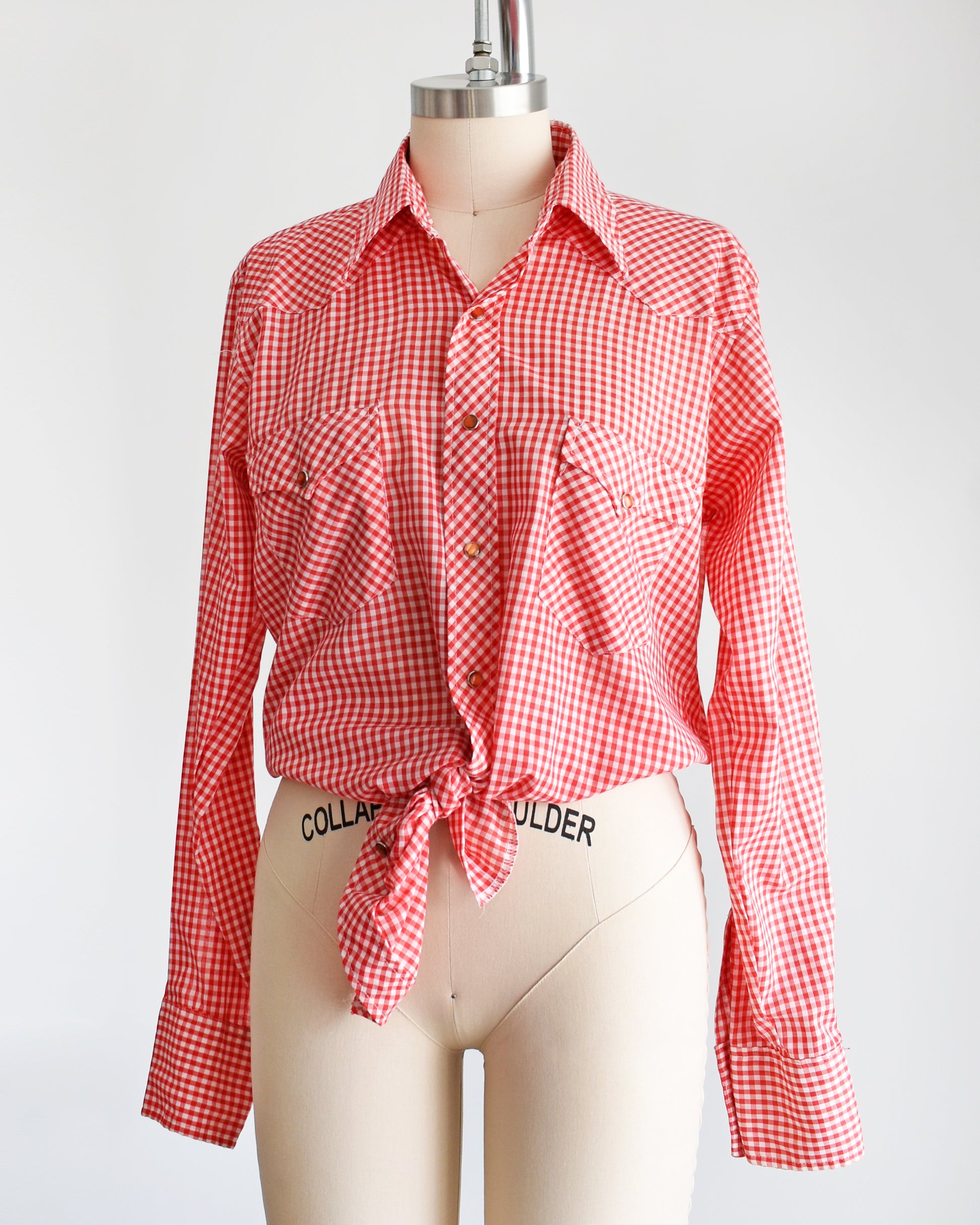 side front view of a vintage 1970s red and white gingham shirt on a mannequin against a white background