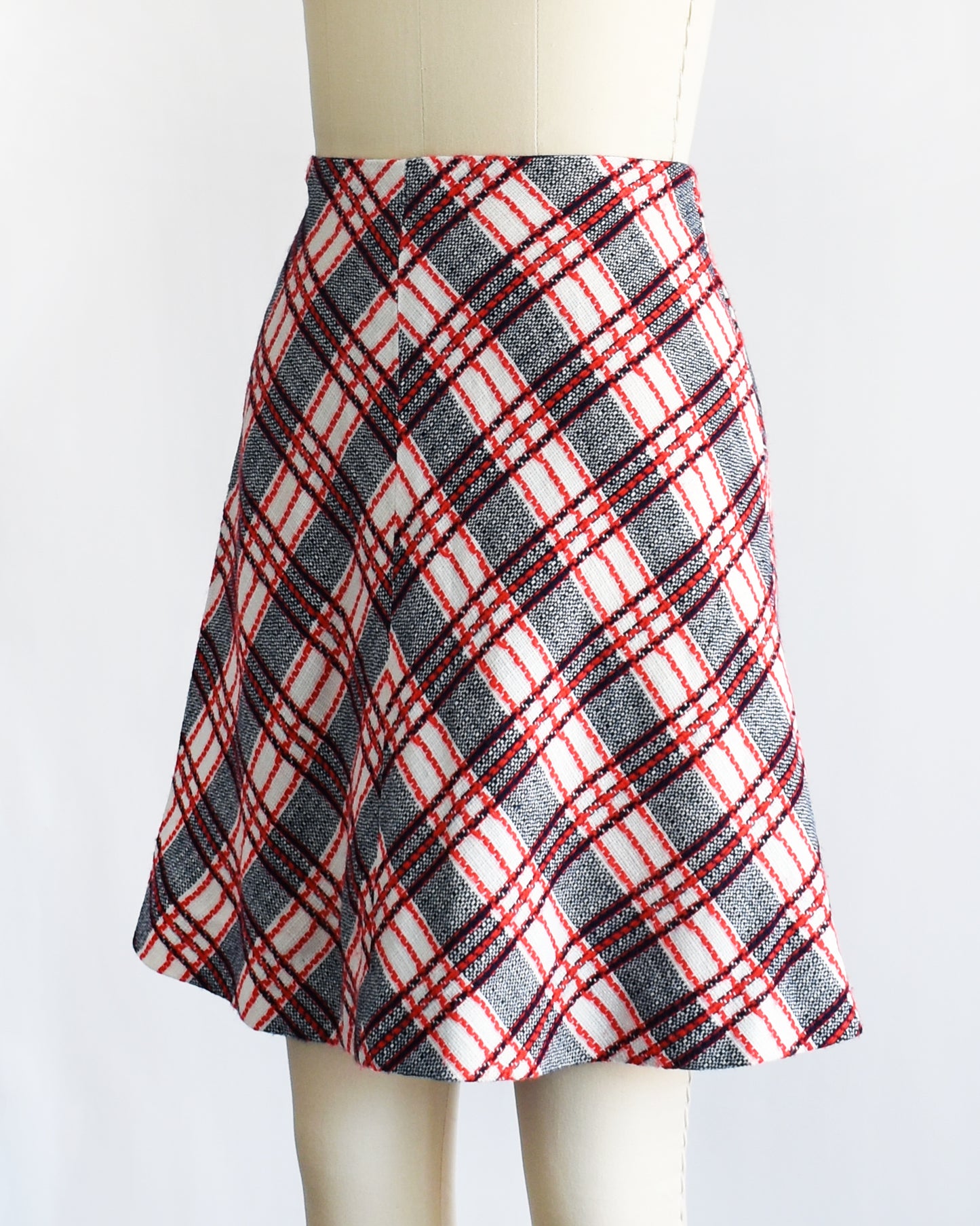 side front view of a vintage plaid skirt on a mannequin against a white background