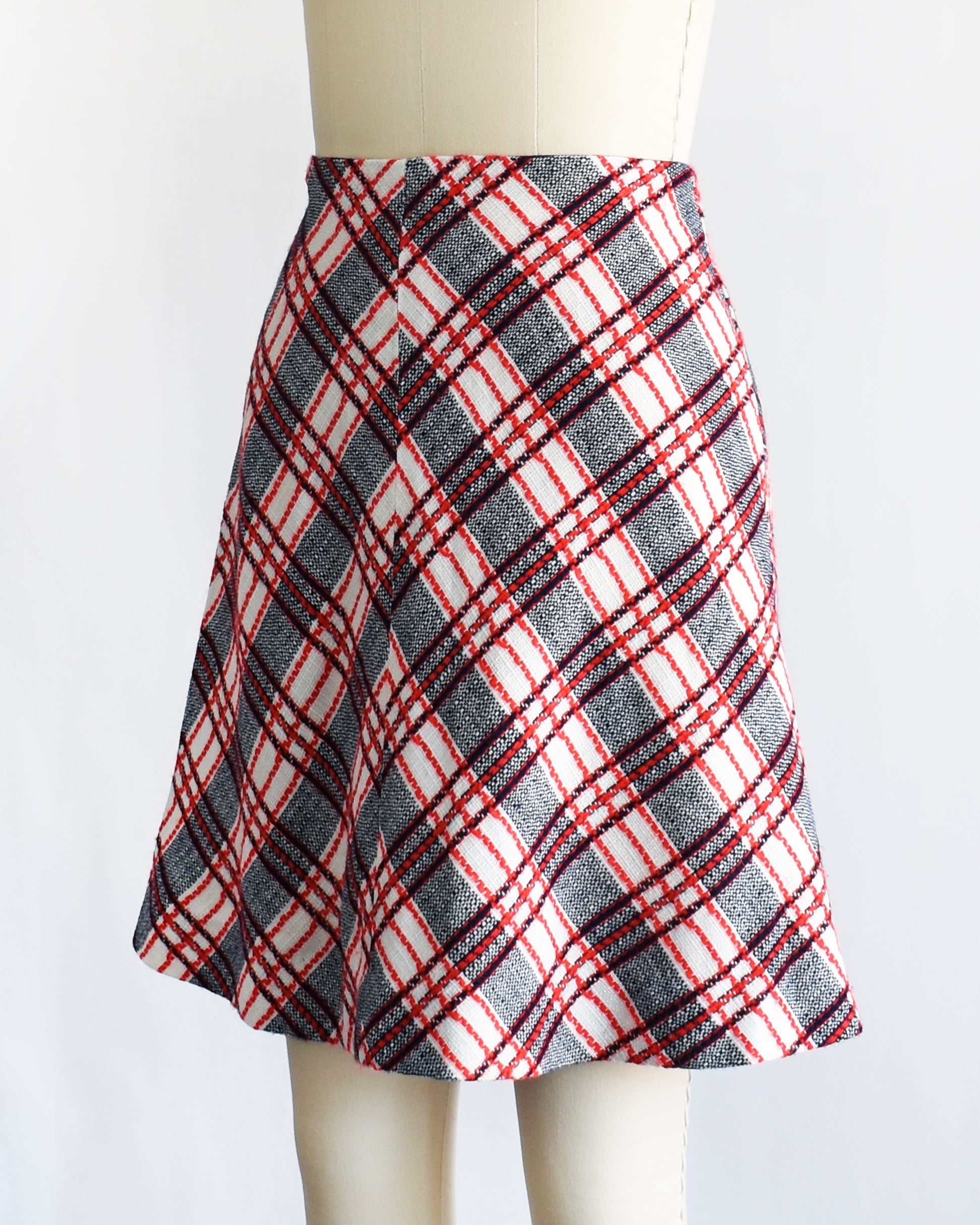 side front view of a vintage plaid skirt on a mannequin against a white background