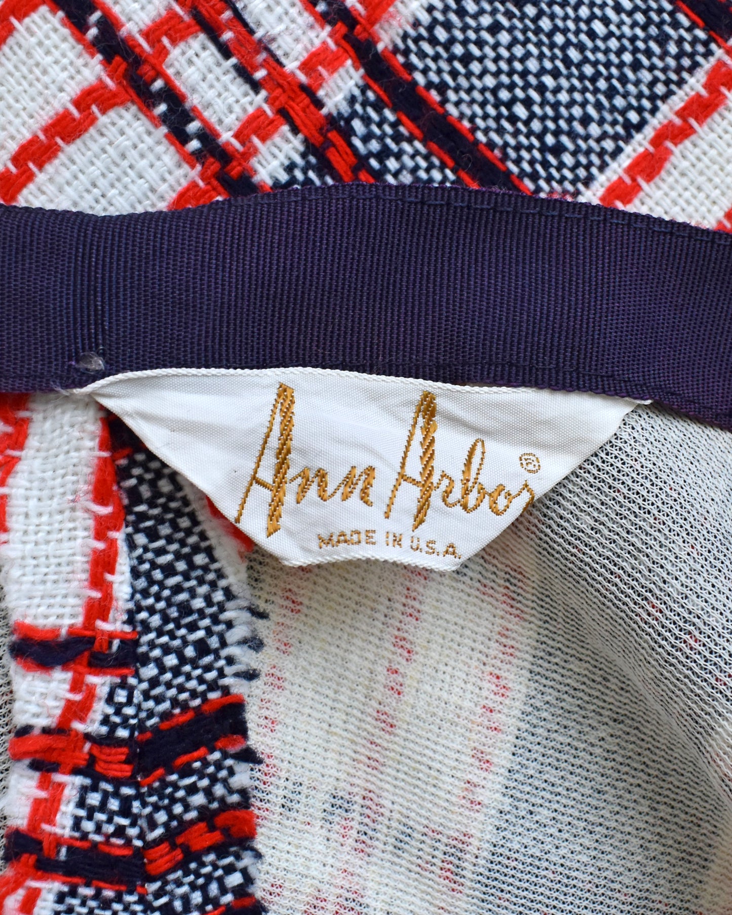 Close-up of a fabric with a plaid pattern and 'Ann Arbor' label.