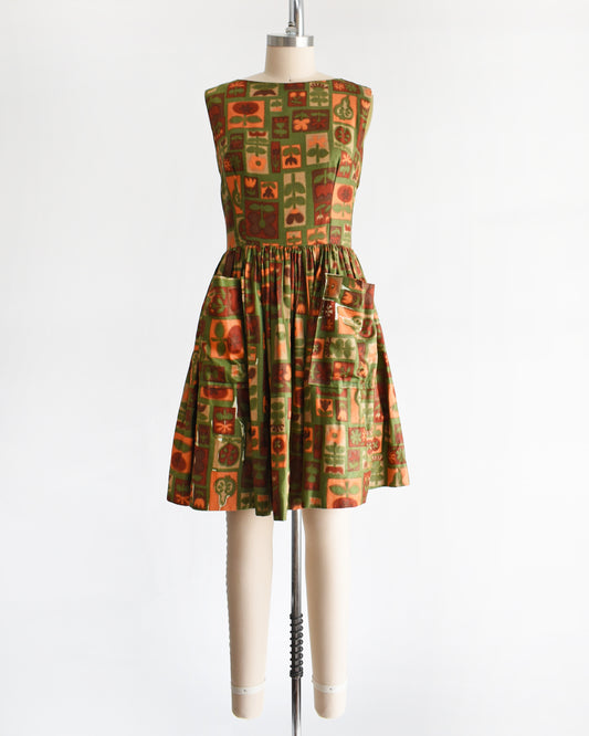 a vintage 1960s fruits and florals patterned dress on a mannequin against a white background