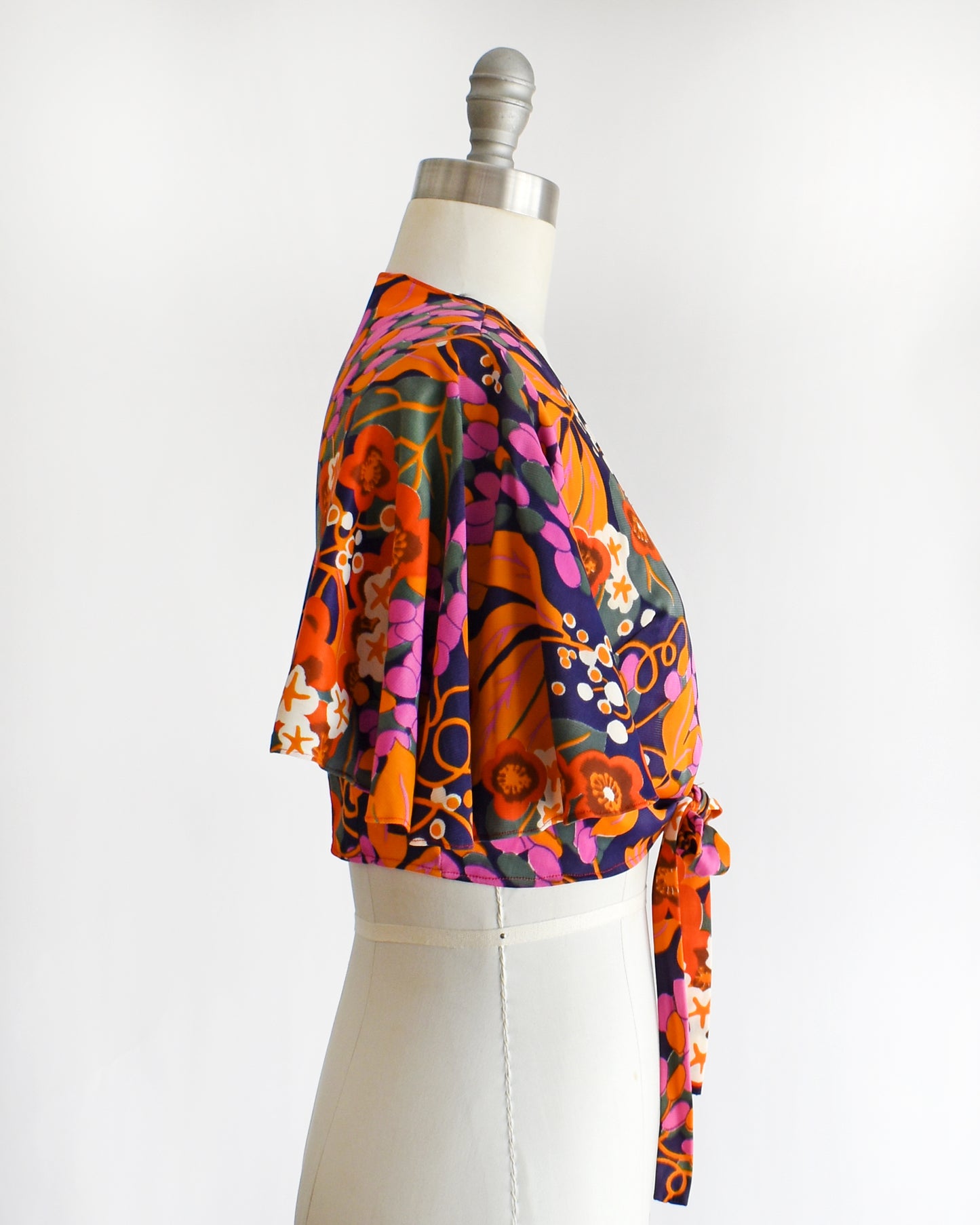 side view of a vintage 70s floral wrap blouse