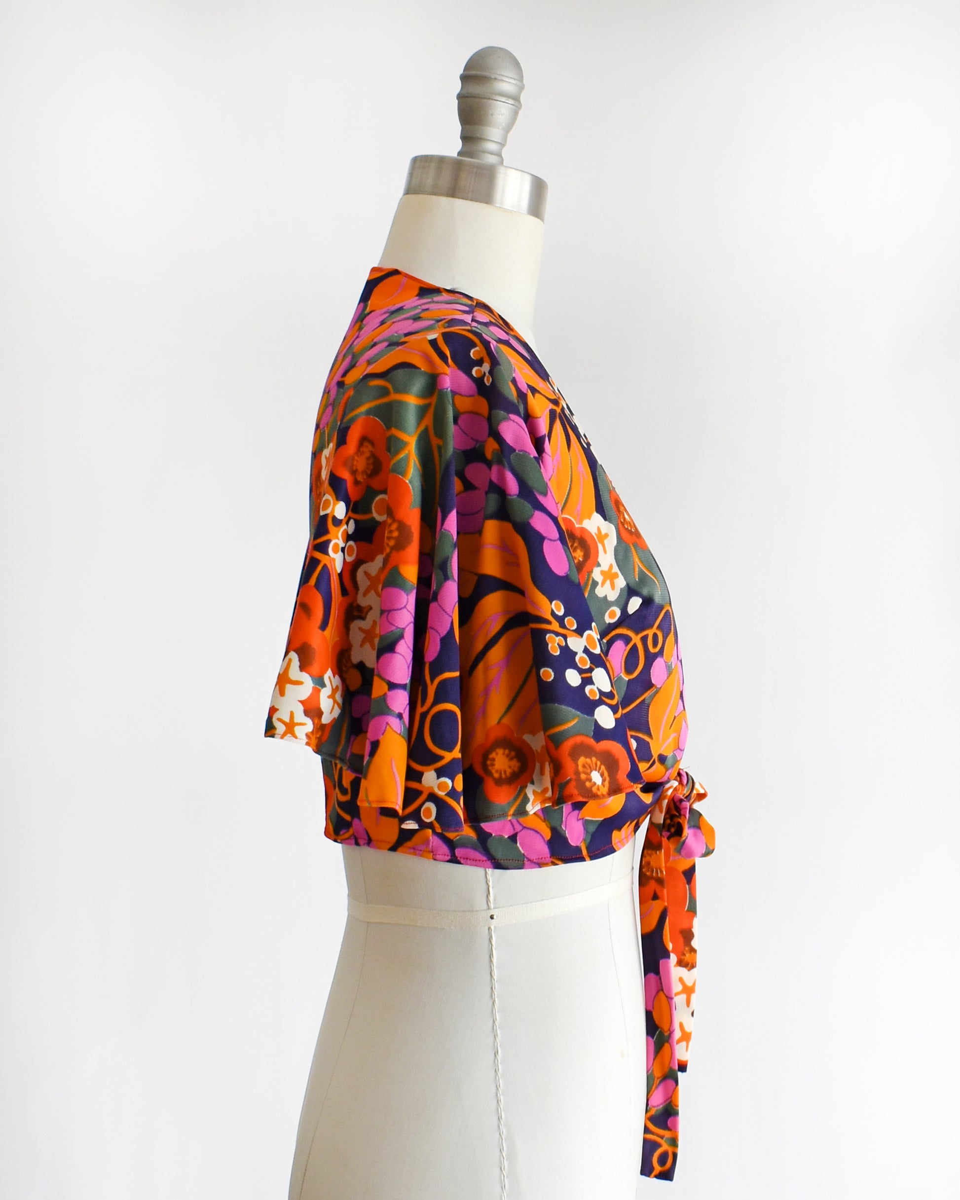 side view of a vintage 70s floral wrap blouse