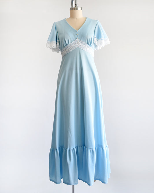 A vintage 1970s blue maxi dress with white lace trim