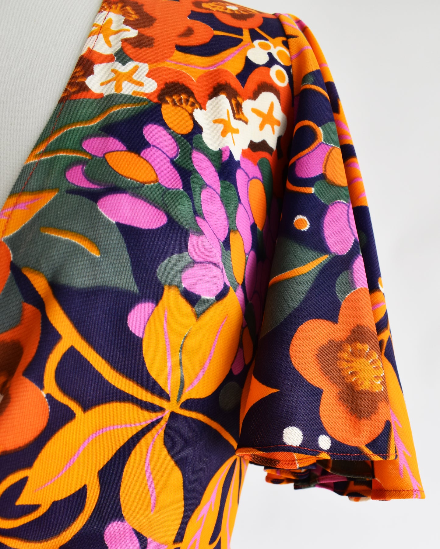 close up of the flutter sleeves on a vintage 70s floral wrap blouse