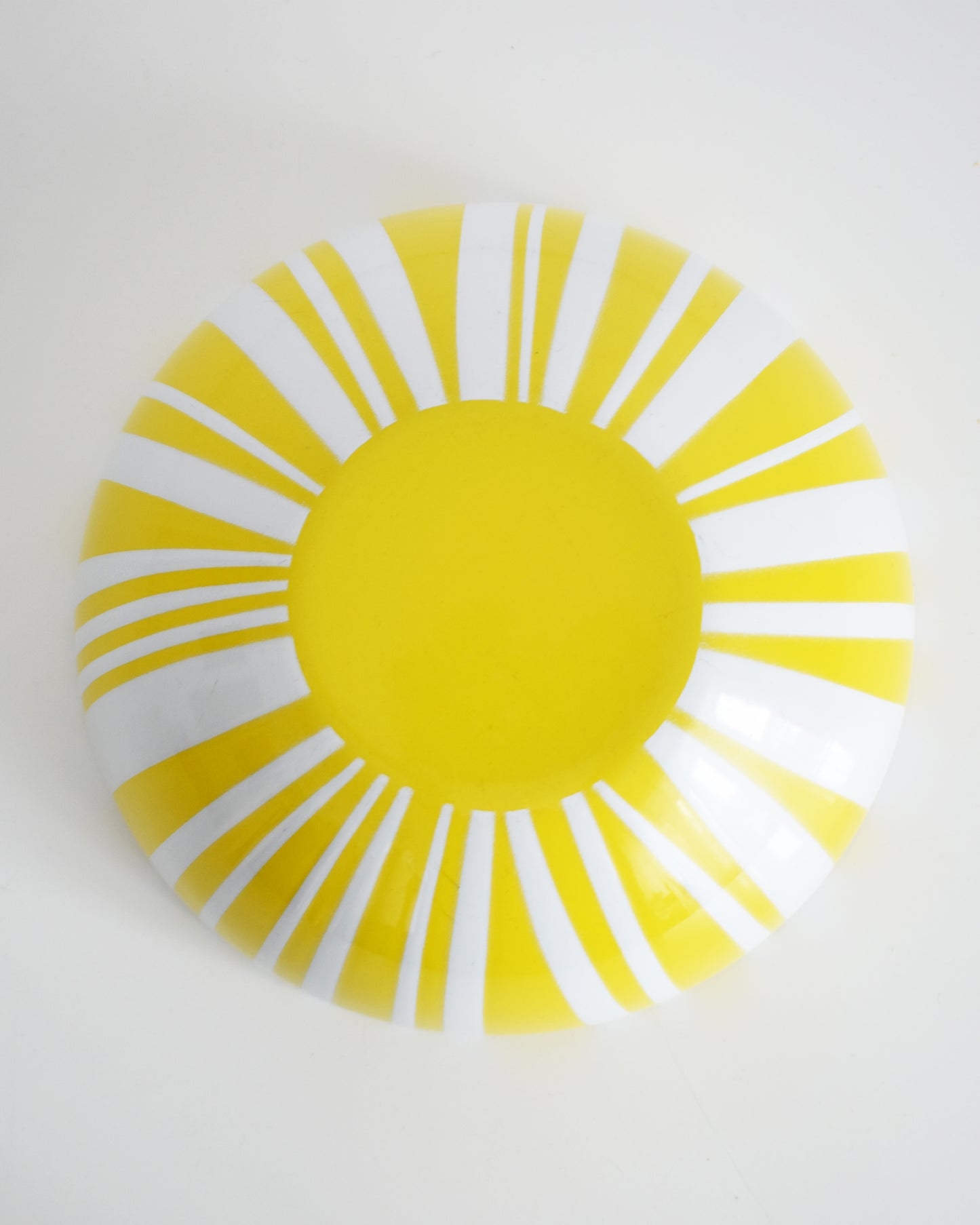 overhead shot of the bottom of a vintage red and white striped Cathrineholm bowl on a white background