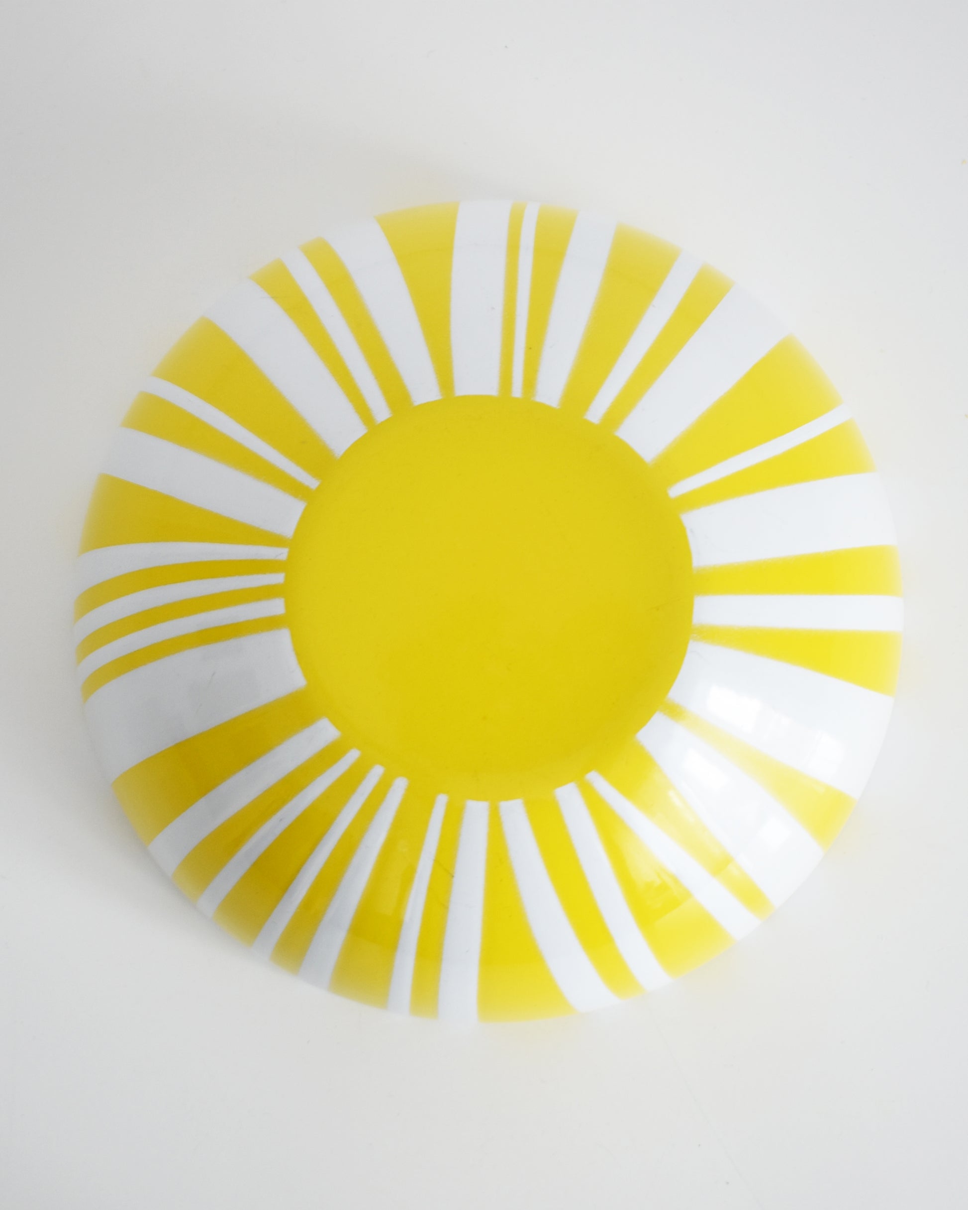 overhead shot of the bottom of a vintage red and white striped Cathrineholm bowl on a white background