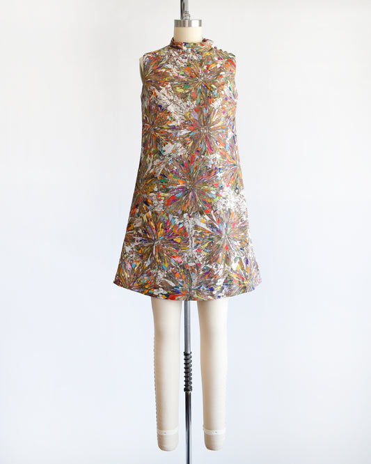 a vintage 1960s mod mini dress that has a multicolored psychedelic kaleidoscope print