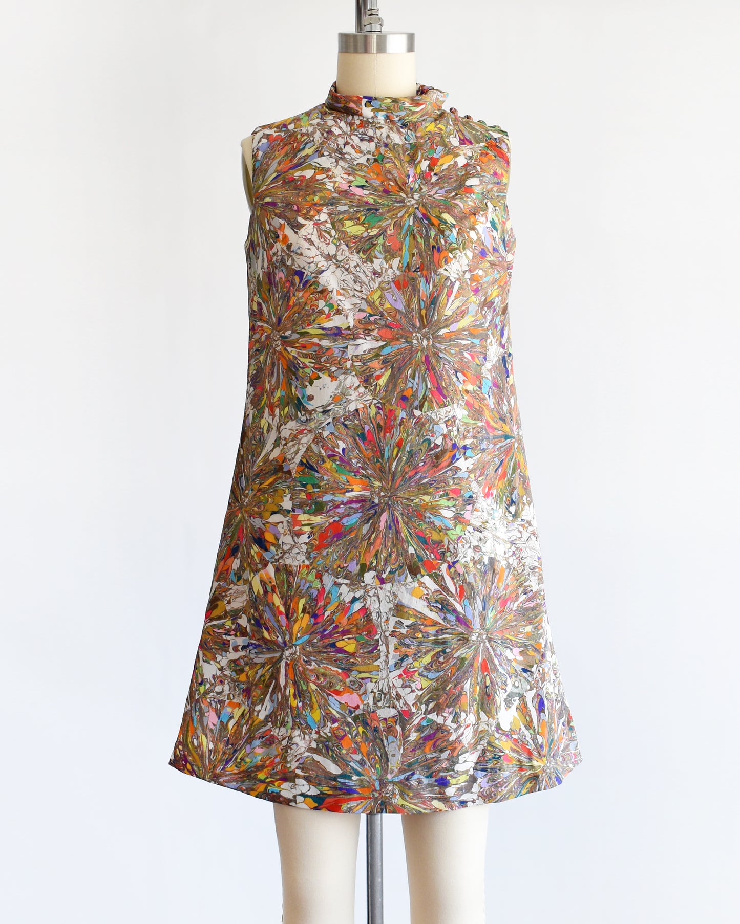 a vintage 1960s mod mini dress that has a multicolored psychedelic kaleidoscope print