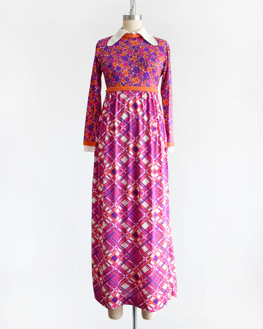 a vintage 1960s/1970s colorful dress with a floral and geometric pattern on a mannequin against a white background