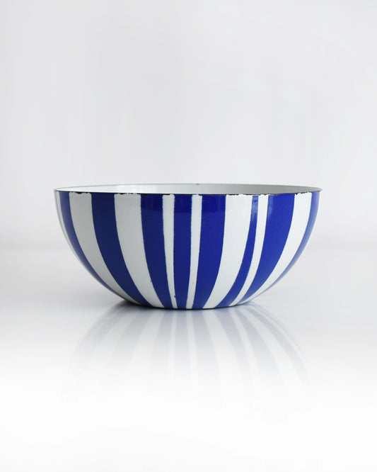 a vintage blue and white striped Cathrineholm bowl on a white background