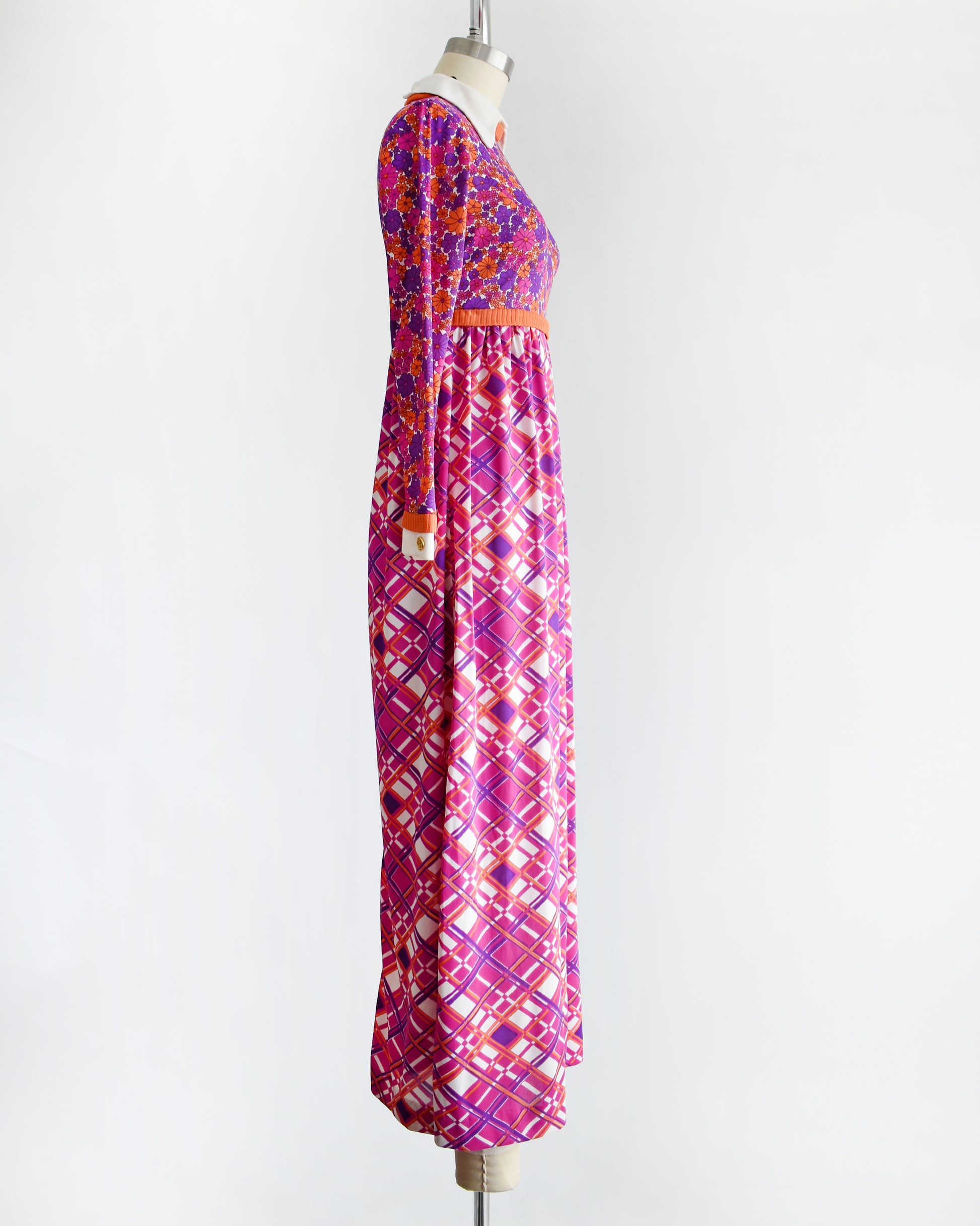 side view of a vintage 1960s/1970s colorful dress with a floral and geometric pattern on a mannequin against a white background