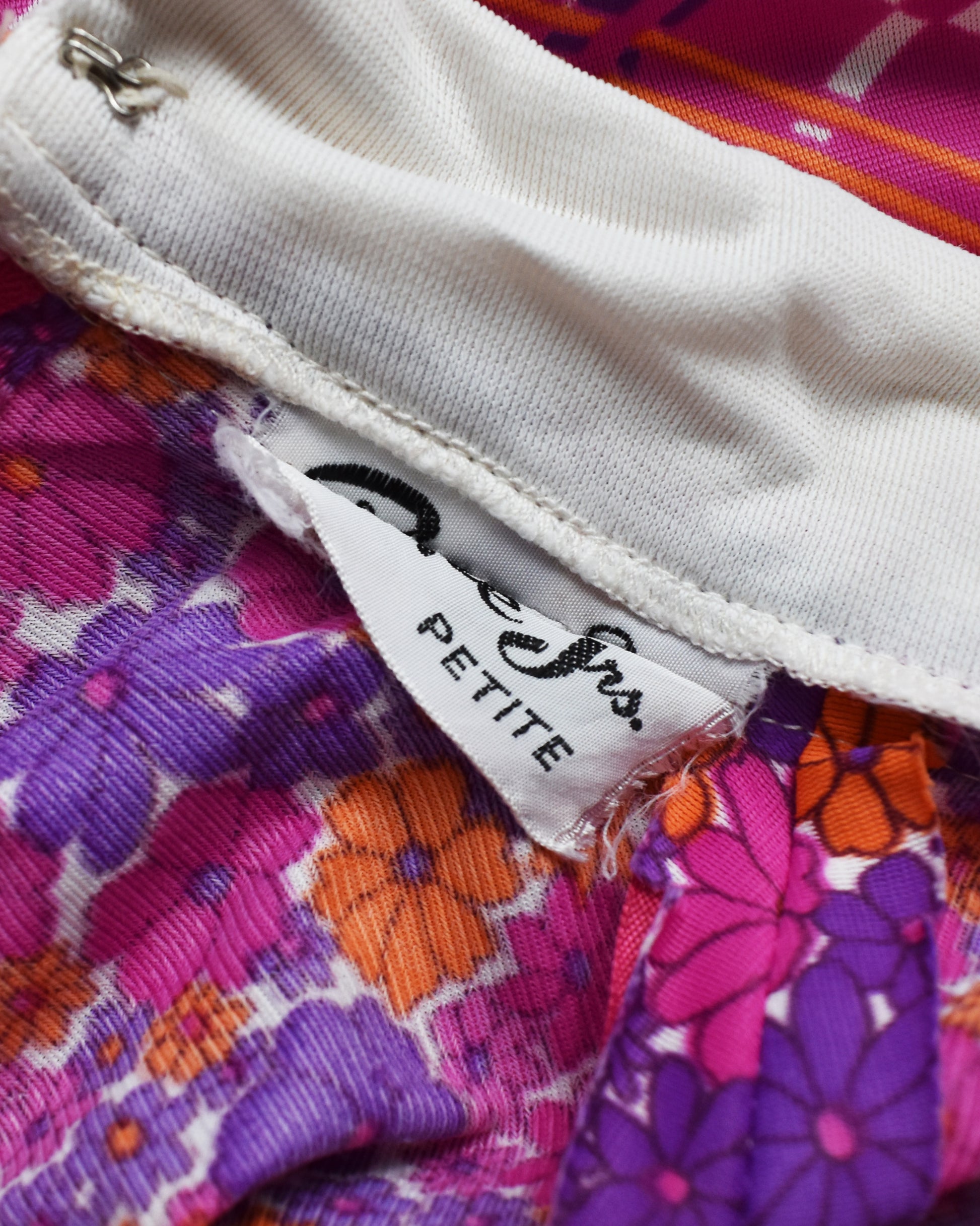 close up of the garment tag that was accidentally sewn into the collar
