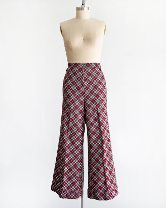 a vintage 1970s burgundy plaid bell bottom pants on a mannequin against a white background
