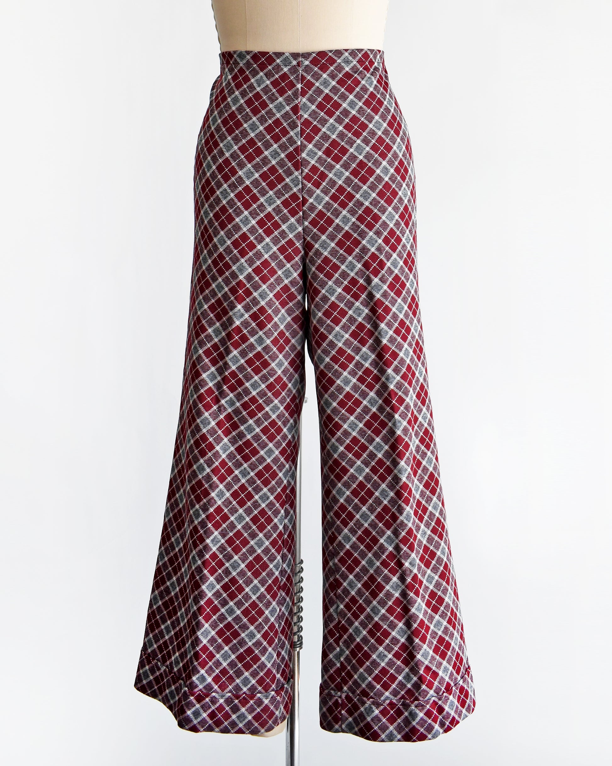 a vintage 1970s burgundy plaid bell bottom pants on a mannequin against a white background