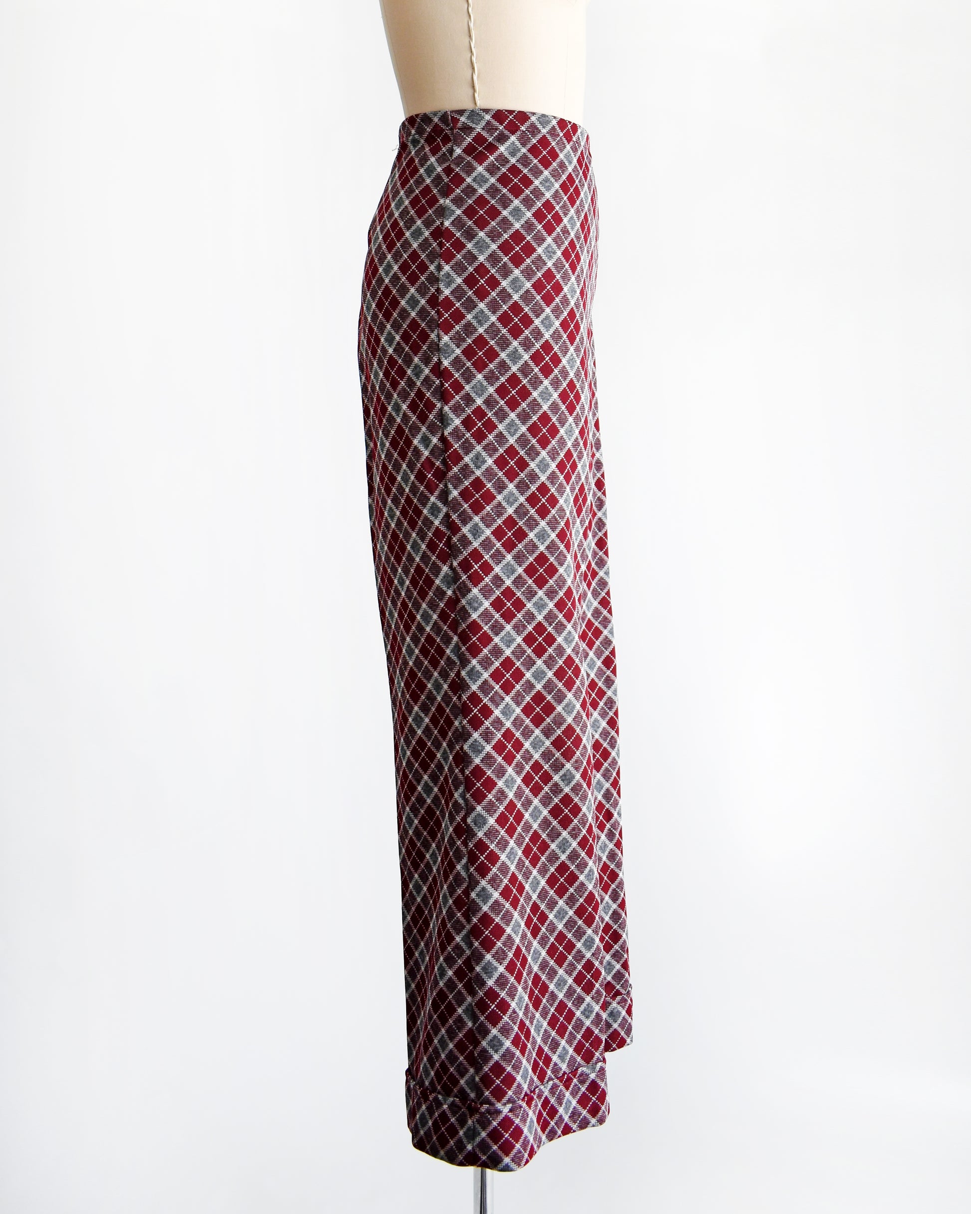 side view of a vintage 1970s burgundy plaid bell bottom pants on a mannequin against a white background