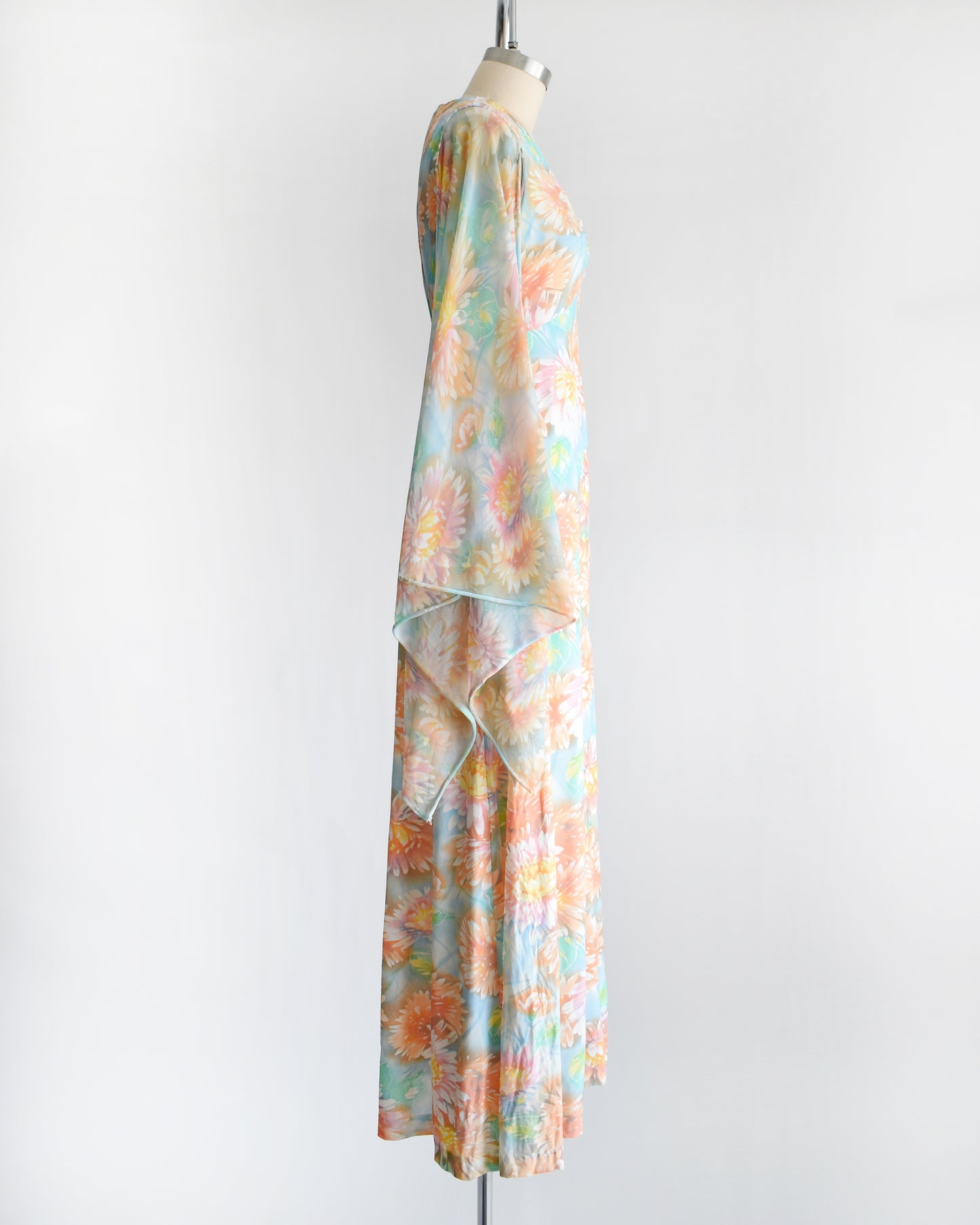 side view of a vintage 1970s floral maxi dress with long angel sleeves