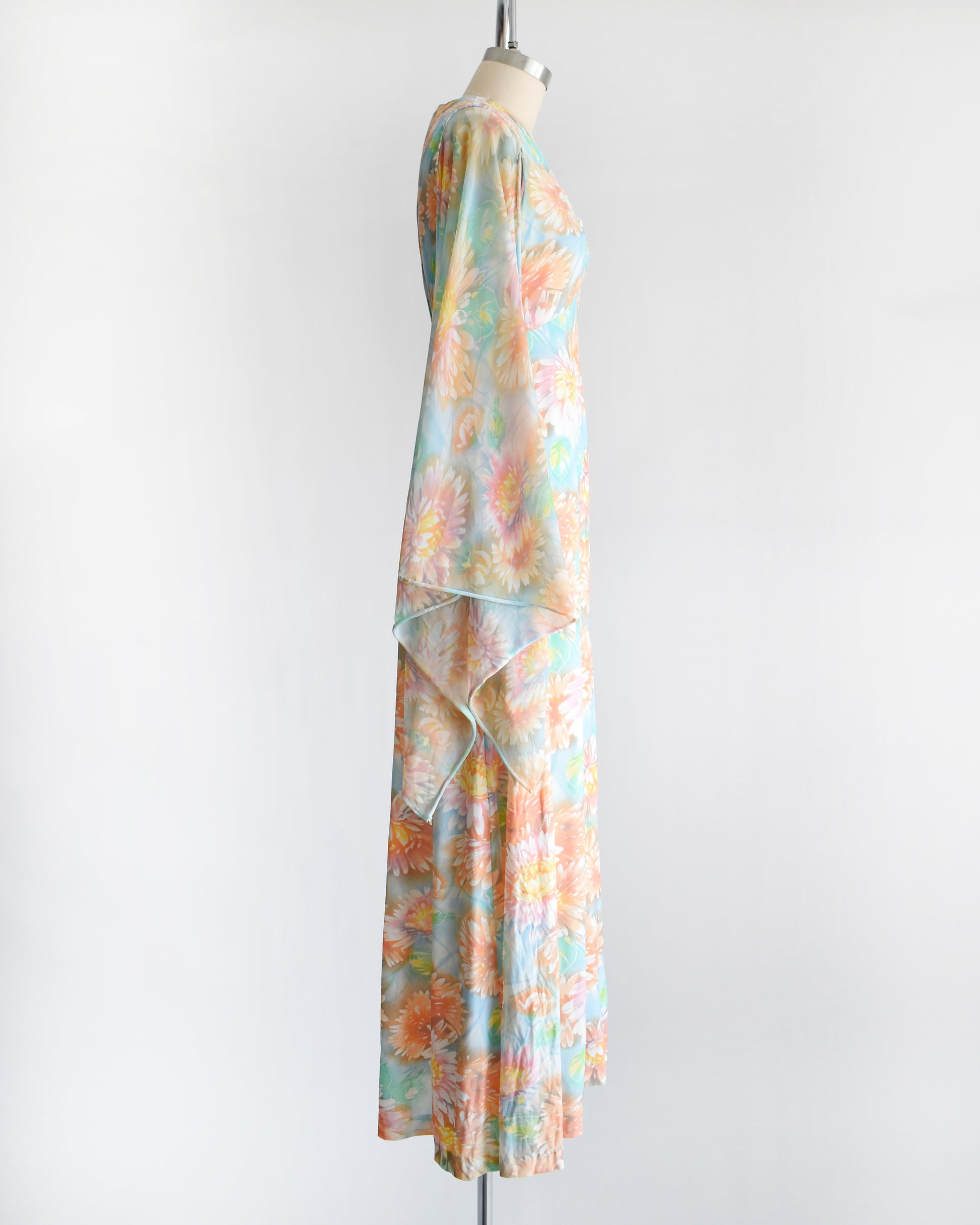 side view of a vintage 1970s floral maxi dress with long angel sleeves