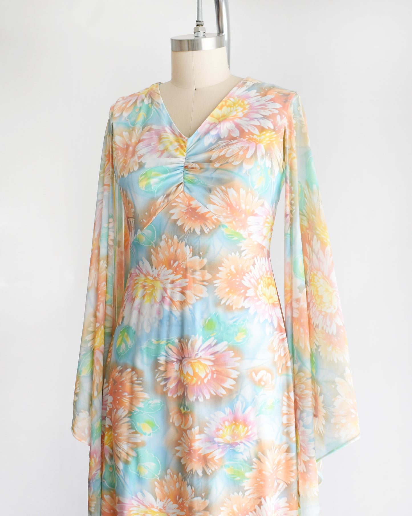 side view of a vintage 1970s floral maxi dress with long angel sleeves
