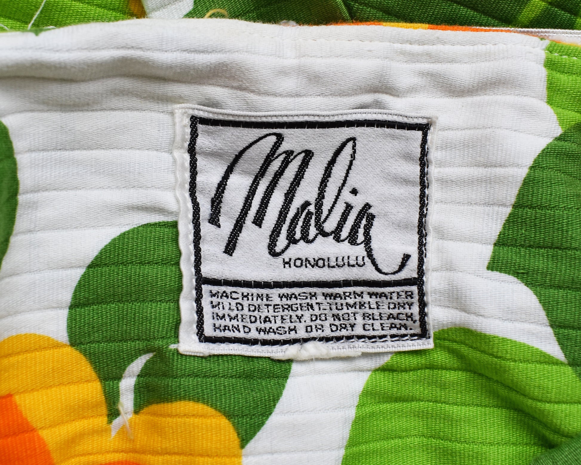 close up of the tag which says Malia Honolulu along with care instructions