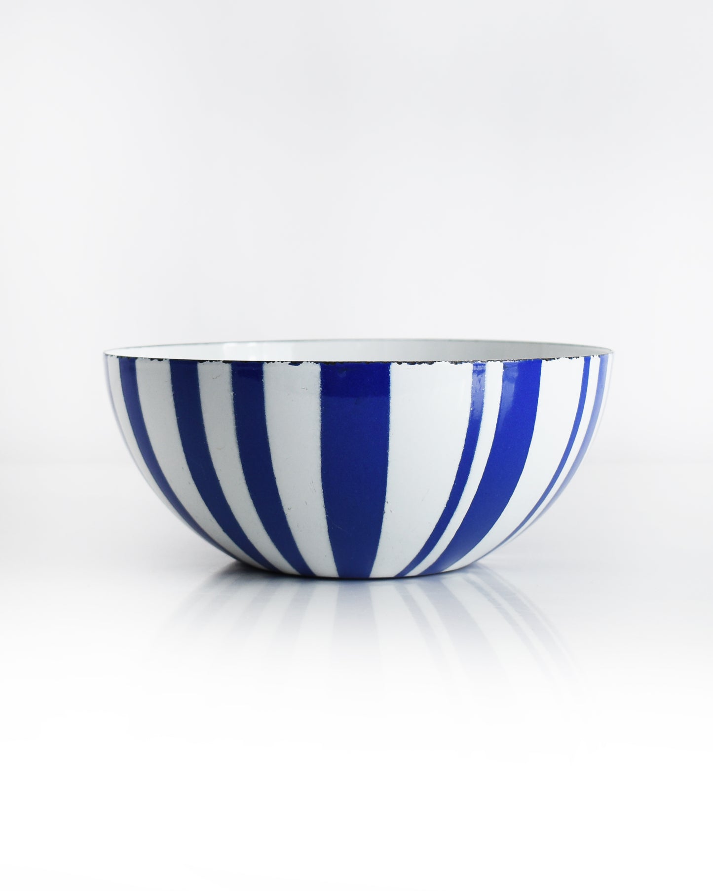 a vintage blue and white striped Cathrineholm bowl on a white background