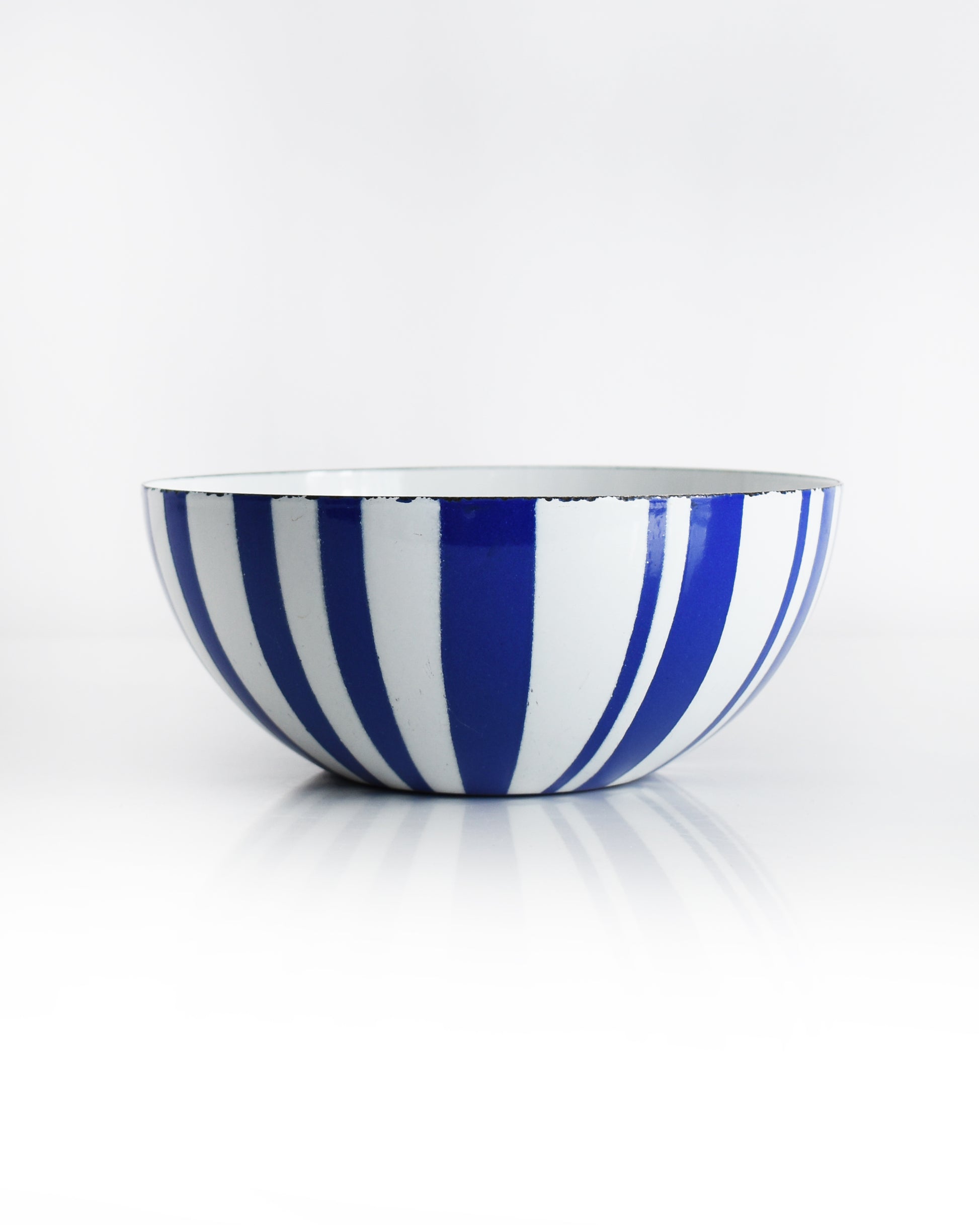 a vintage blue and white striped Cathrineholm bowl on a white background