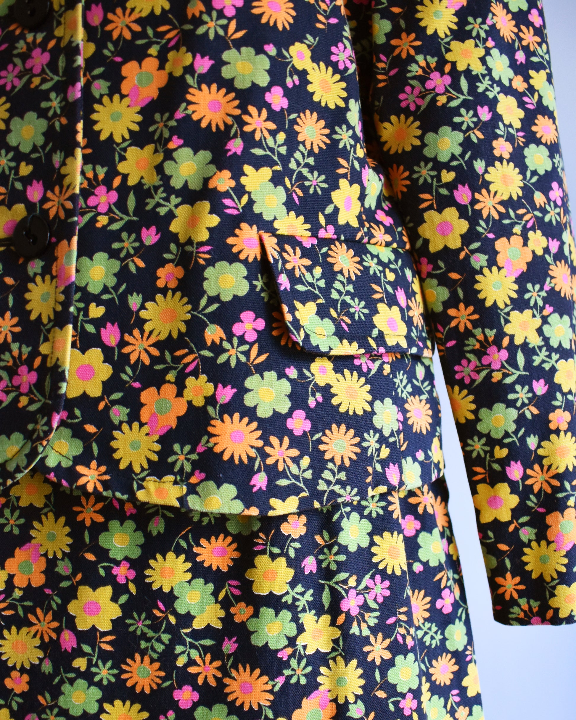 close up of the black floral pattern on the blazer and skirt