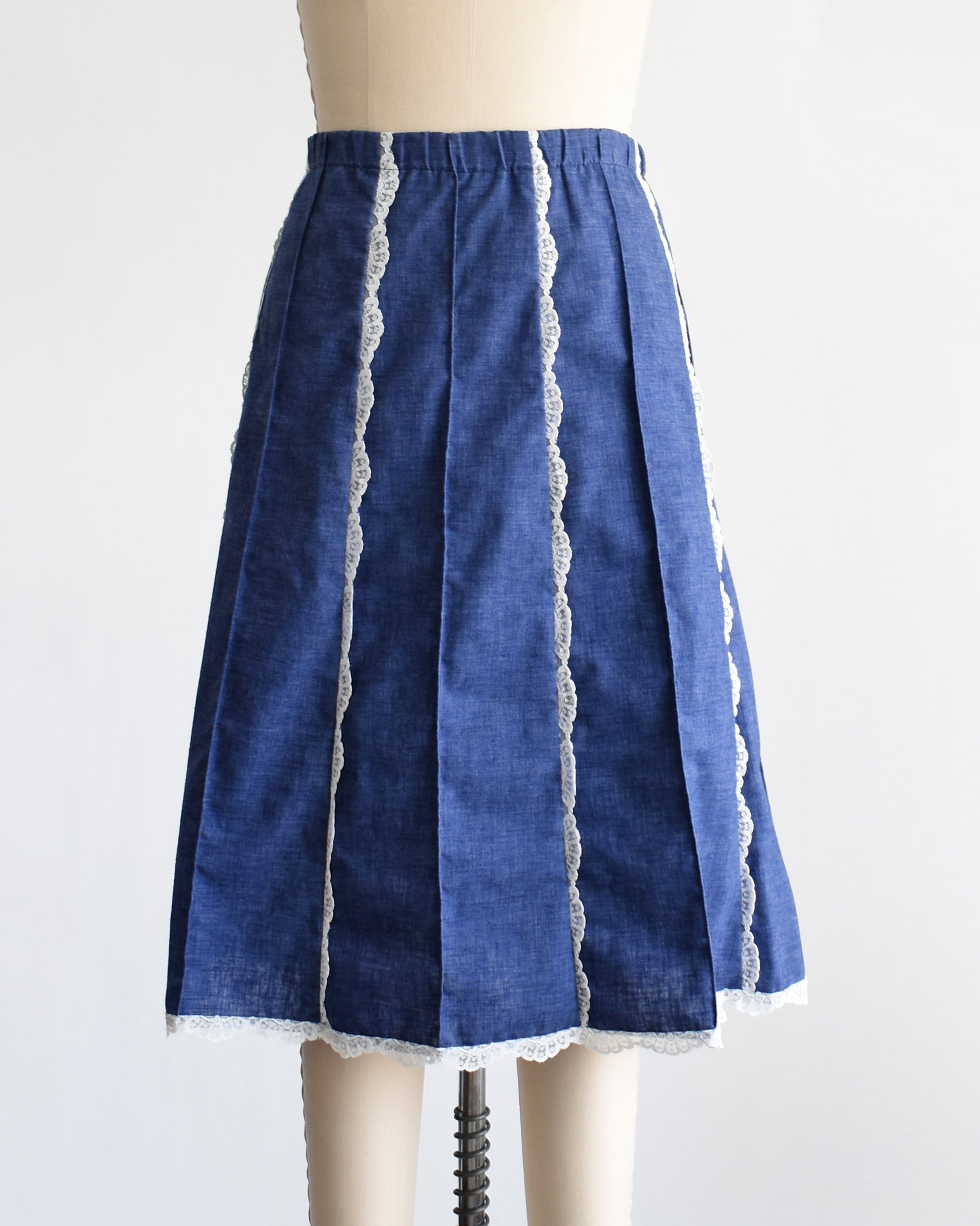 a vintage 1970s blue chambray lace skirt on a dress form against a white background
