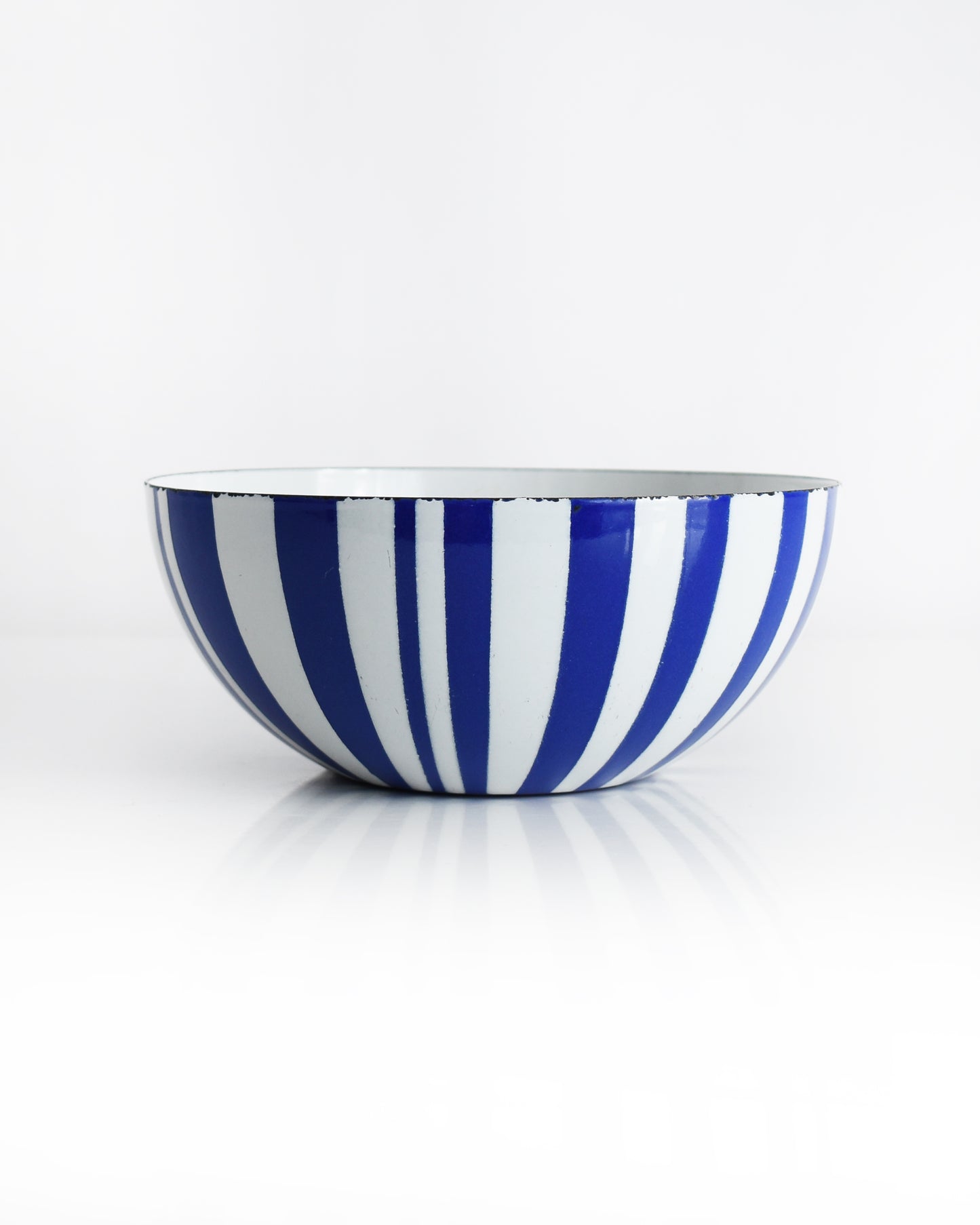 a vintage blue and white striped Cathrineholm bowl on a white background
