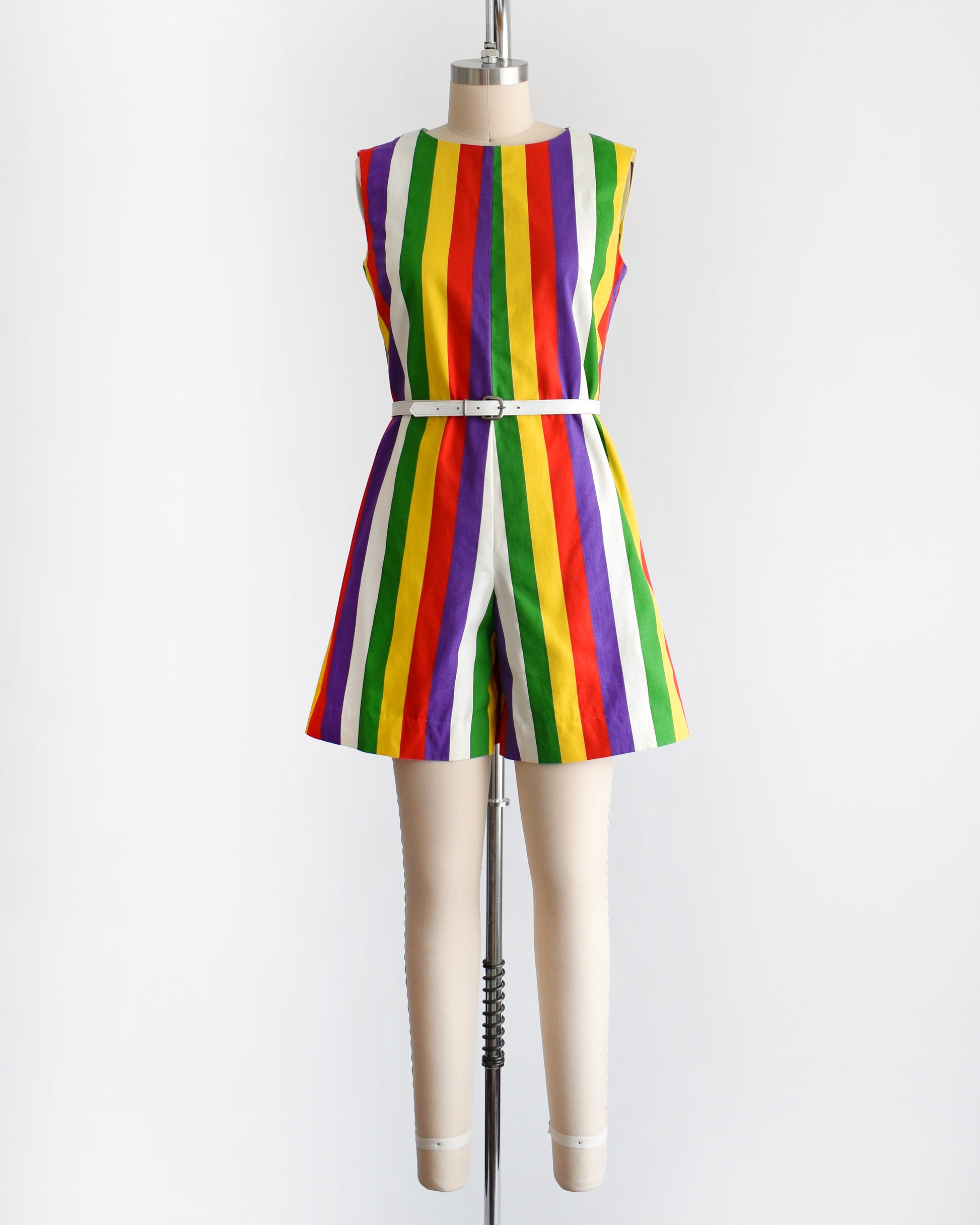 a vintage 1960s rainbow striped romper on a dress form. there is a white belt around the waist which is not included.