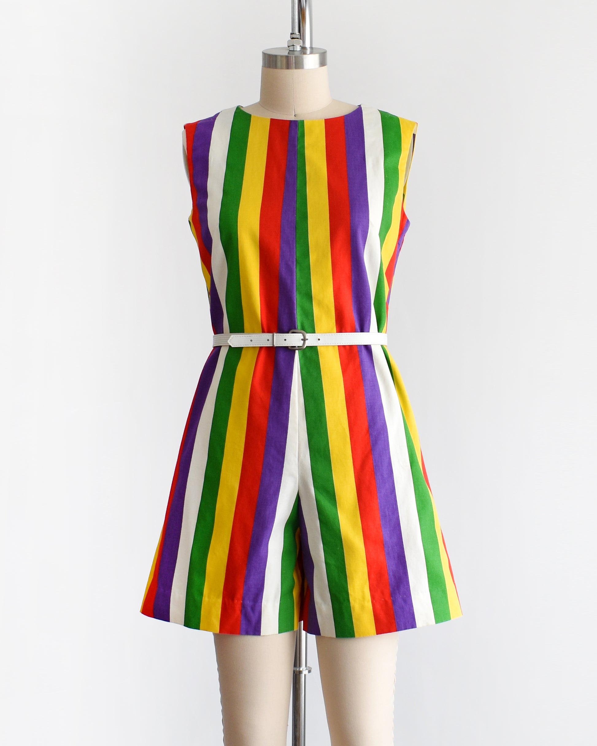 a vintage 1960s rainbow striped romper on a dress form. there is a white belt around the waist which is not included.