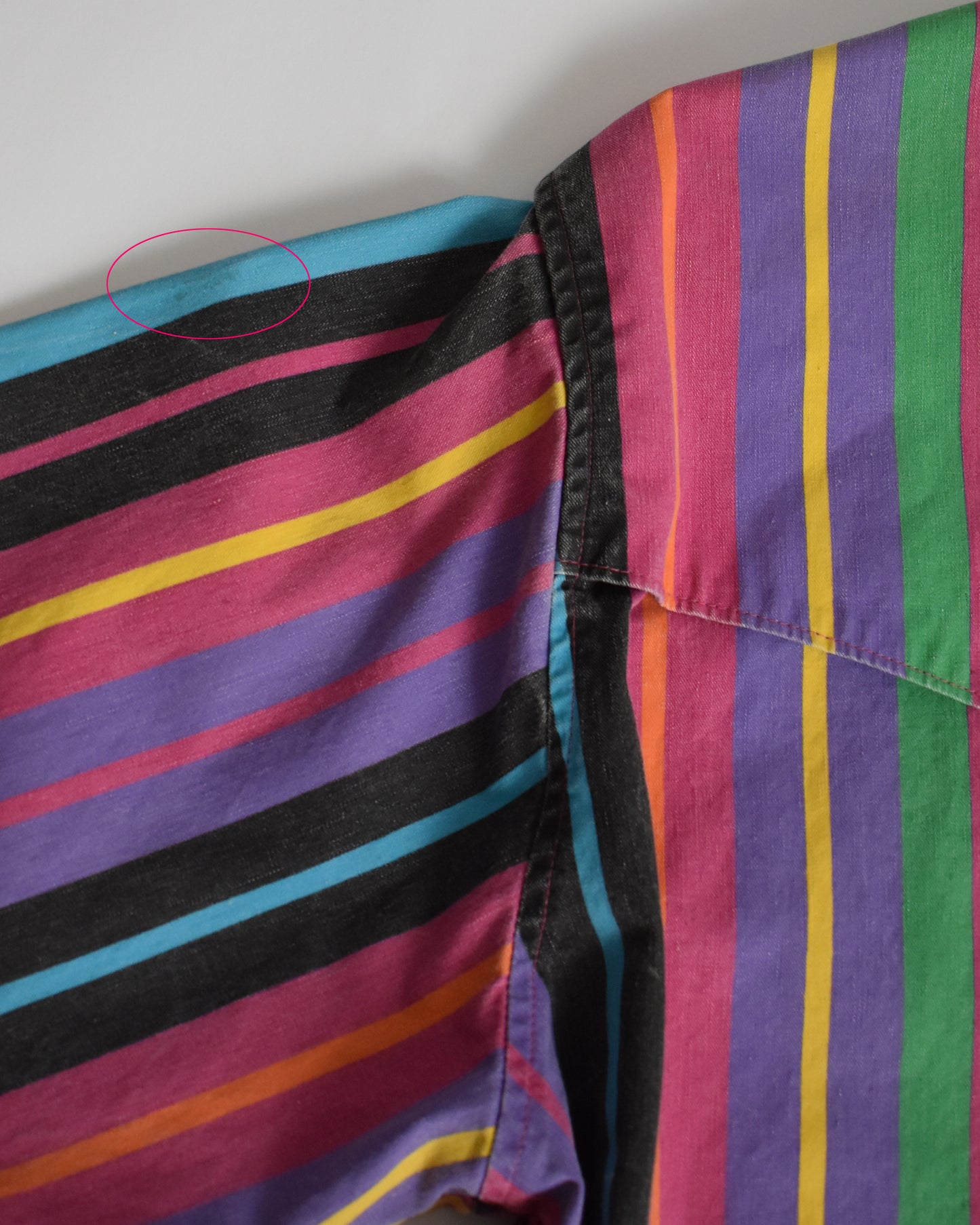 the back of the shirt that shows a circle that shows a small stain