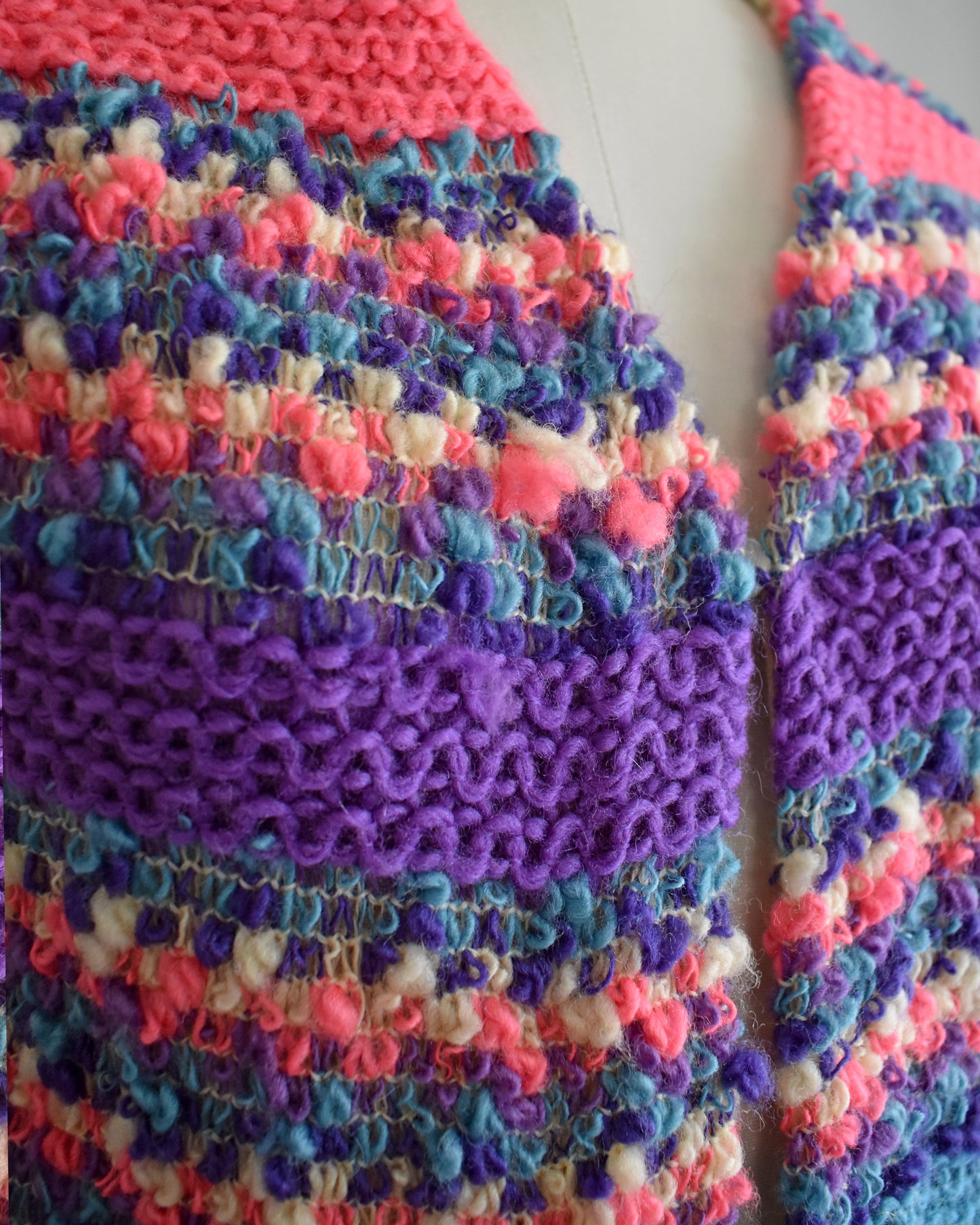 Close-up of a colorful striped wool with purple and pink patterns.