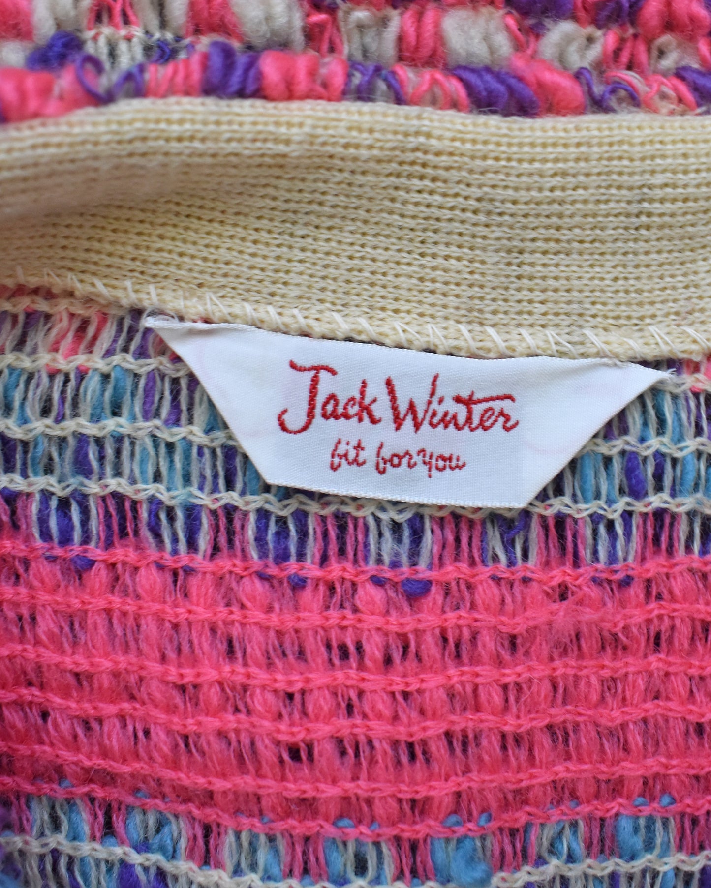 Close-up of a colorful woven fabric with a 'Jack Winter' label.
