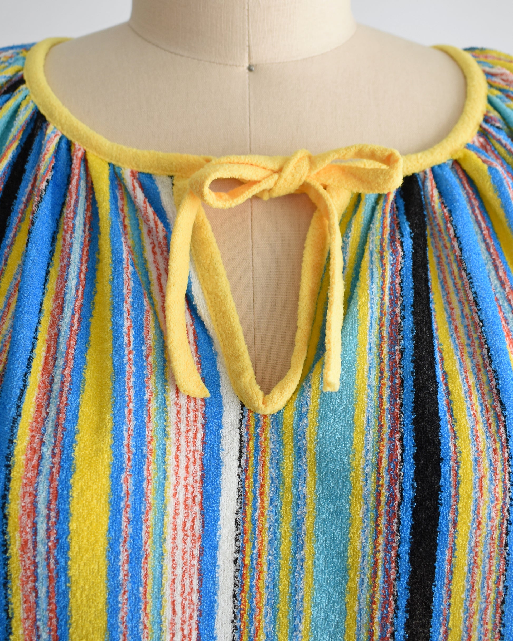 close up of the tied keyhole neckline of a vintage striped terry cloth cover up dress