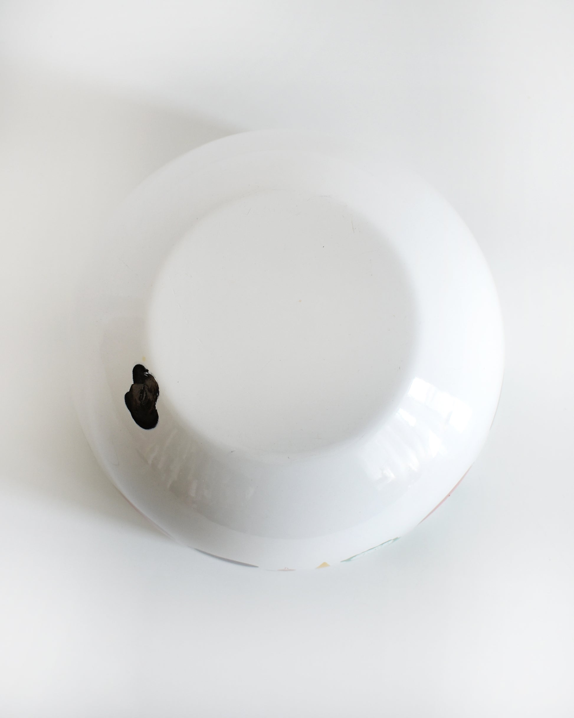 overhead shot of the bottom of a vintage Kaj Franck for Arabia Finland vegetable & fruit enamel bow. a spot of enamel is missing