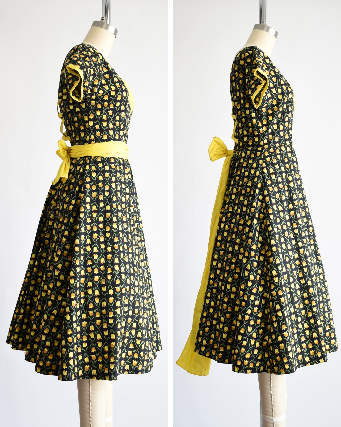 side by side view of a vintage 1950s black fit and flare dress with a yellow floral print and yellow waist sash. the waist sash can be worn in a few different ways: wrapped around or tied in the back