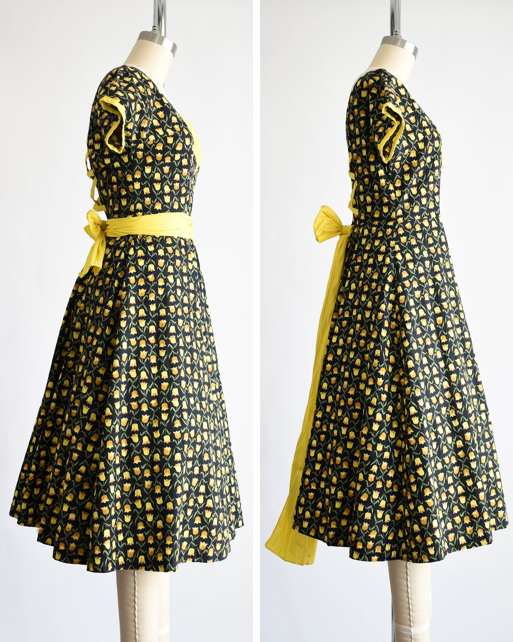 side by side view of a vintage 1950s black fit and flare dress with a yellow floral print and yellow waist sash. the waist sash can be worn in a few different ways: wrapped around or tied in the back