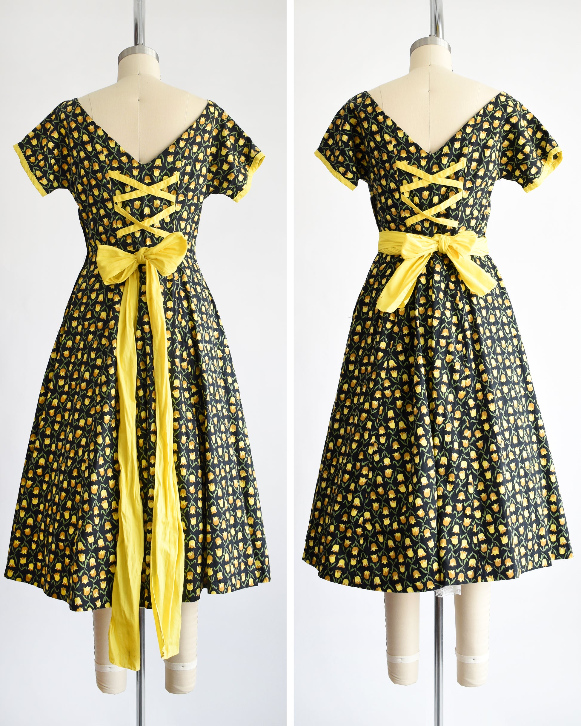 back view of a vintage 1950s black fit and flare dress with a yellow floral print and yellow waistband. the waist sash can be worn in a few different ways: wrapped around or tied in the back