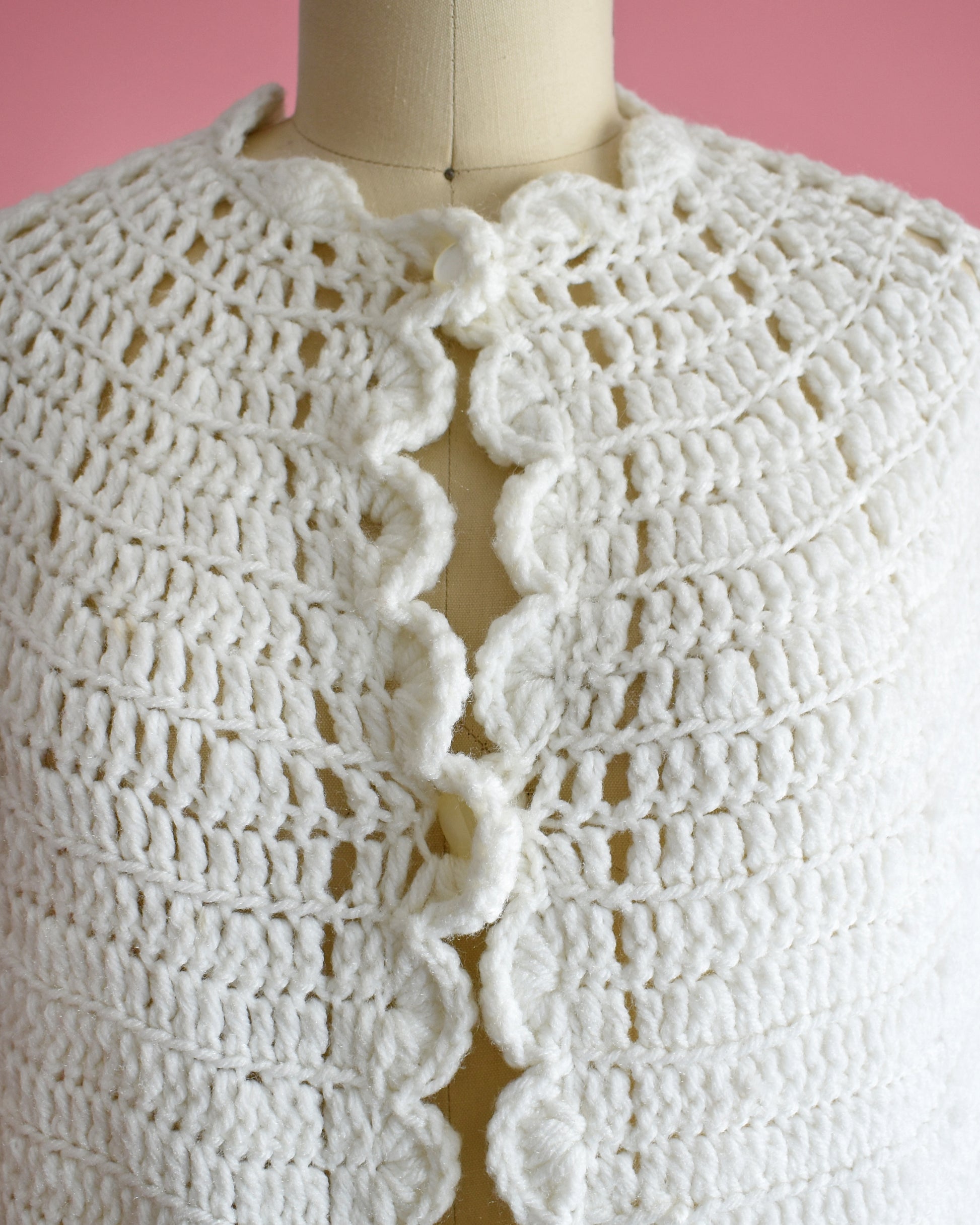 close up of the two buttons and keyhole opening on the top part of the poncho