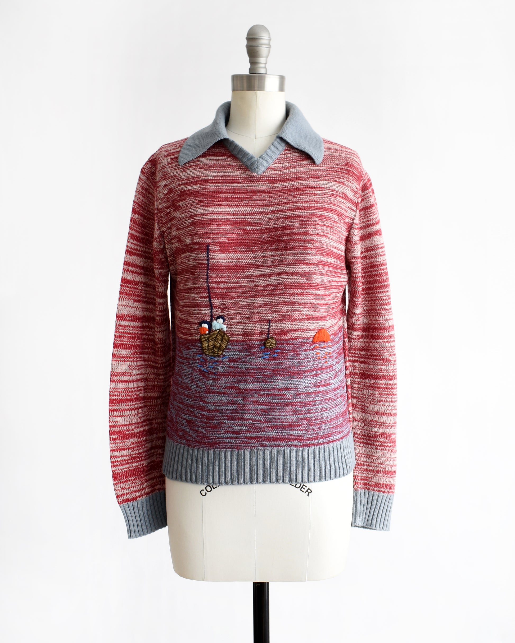 a vintage 1970s red space dye sweater with fishing boating design on a mannequin against a white background