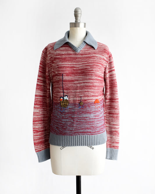 a vintage 1970s red space dye sweater with fishing boating design on a mannequin against a white background