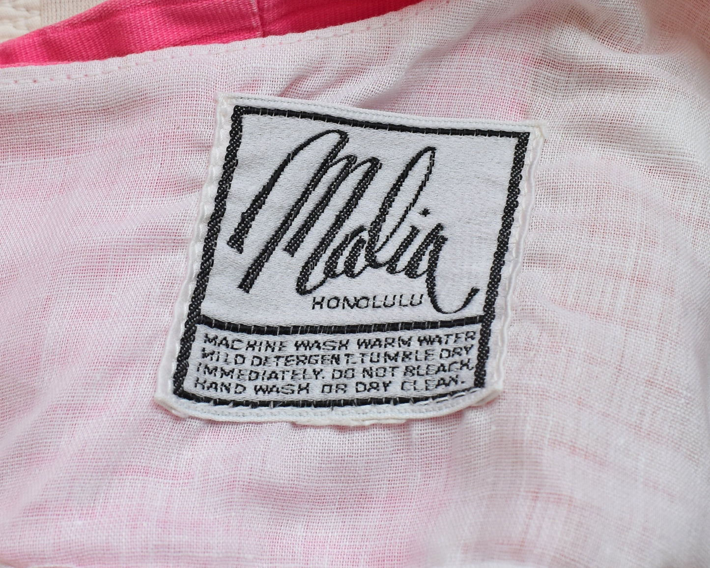 close up of the tag which says Malia Honolulu and care instructions