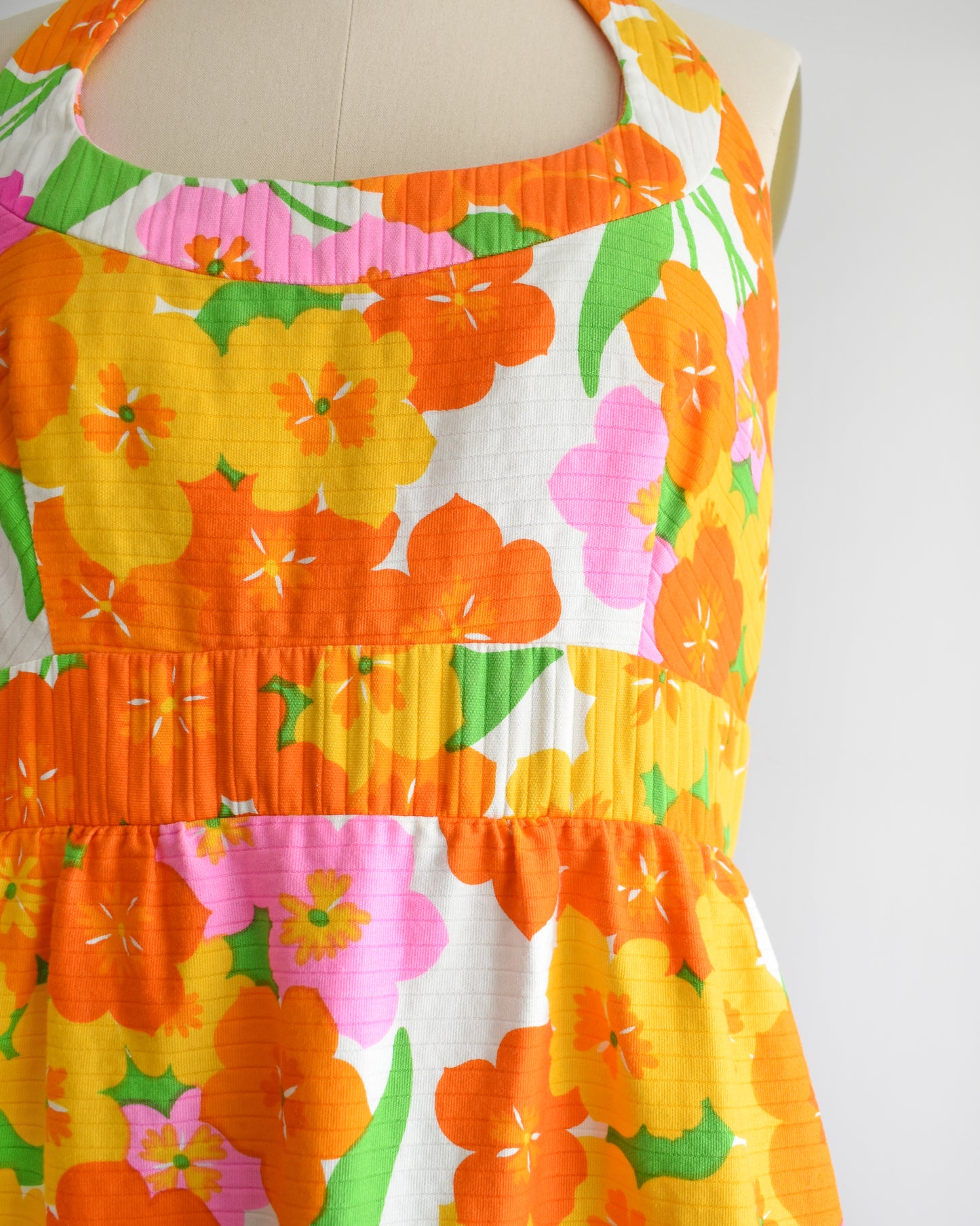 close up of the bodice and waistline which shows the ribbed texture and colorful floral print