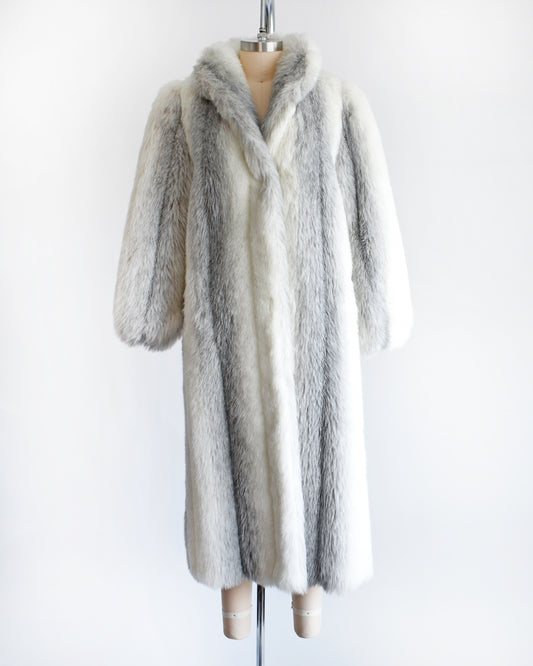 a vintage 1980s faux fur coat on a mannequin against a white background