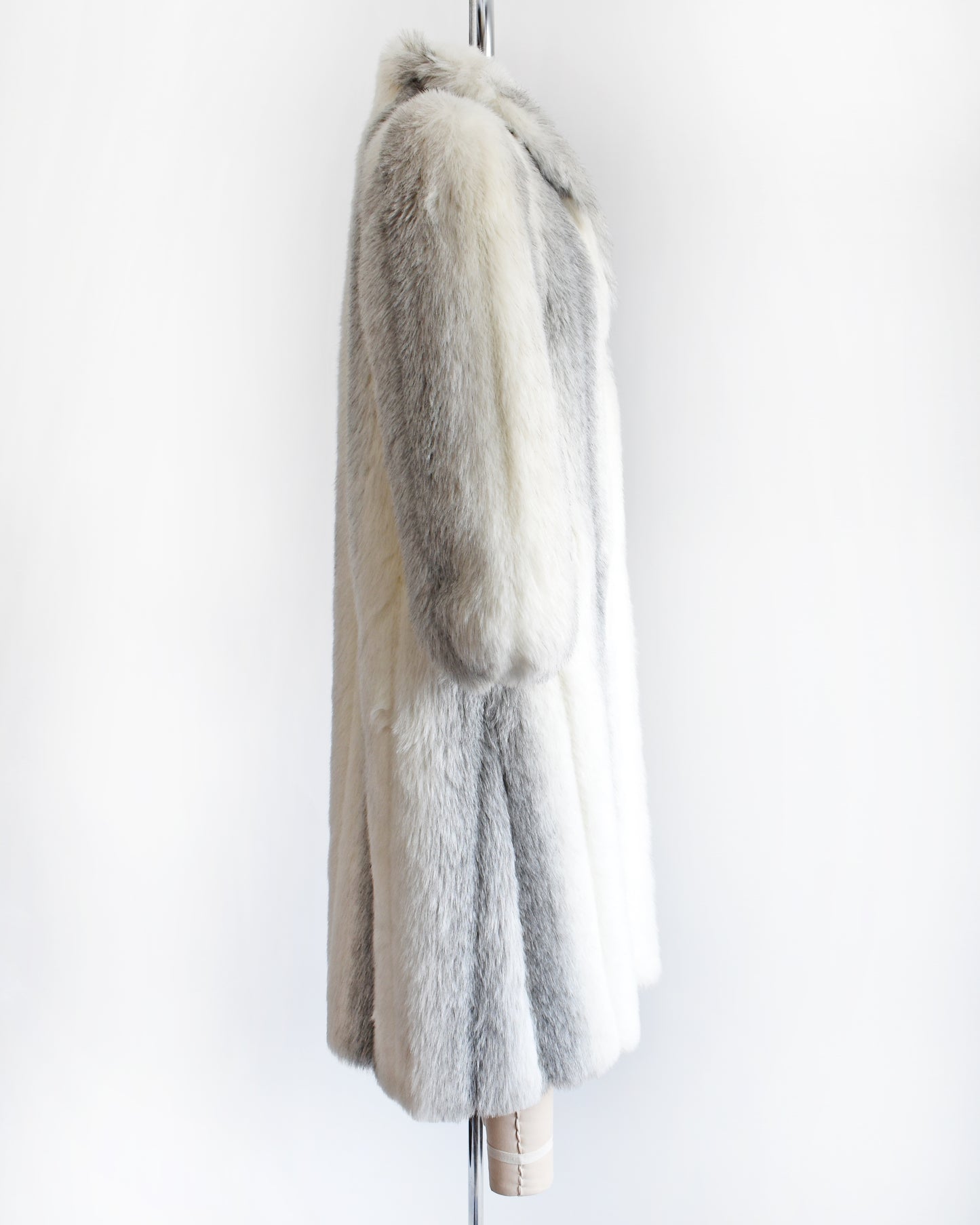 side view of a vintage 1980s faux fur coat on a mannequin against a white background