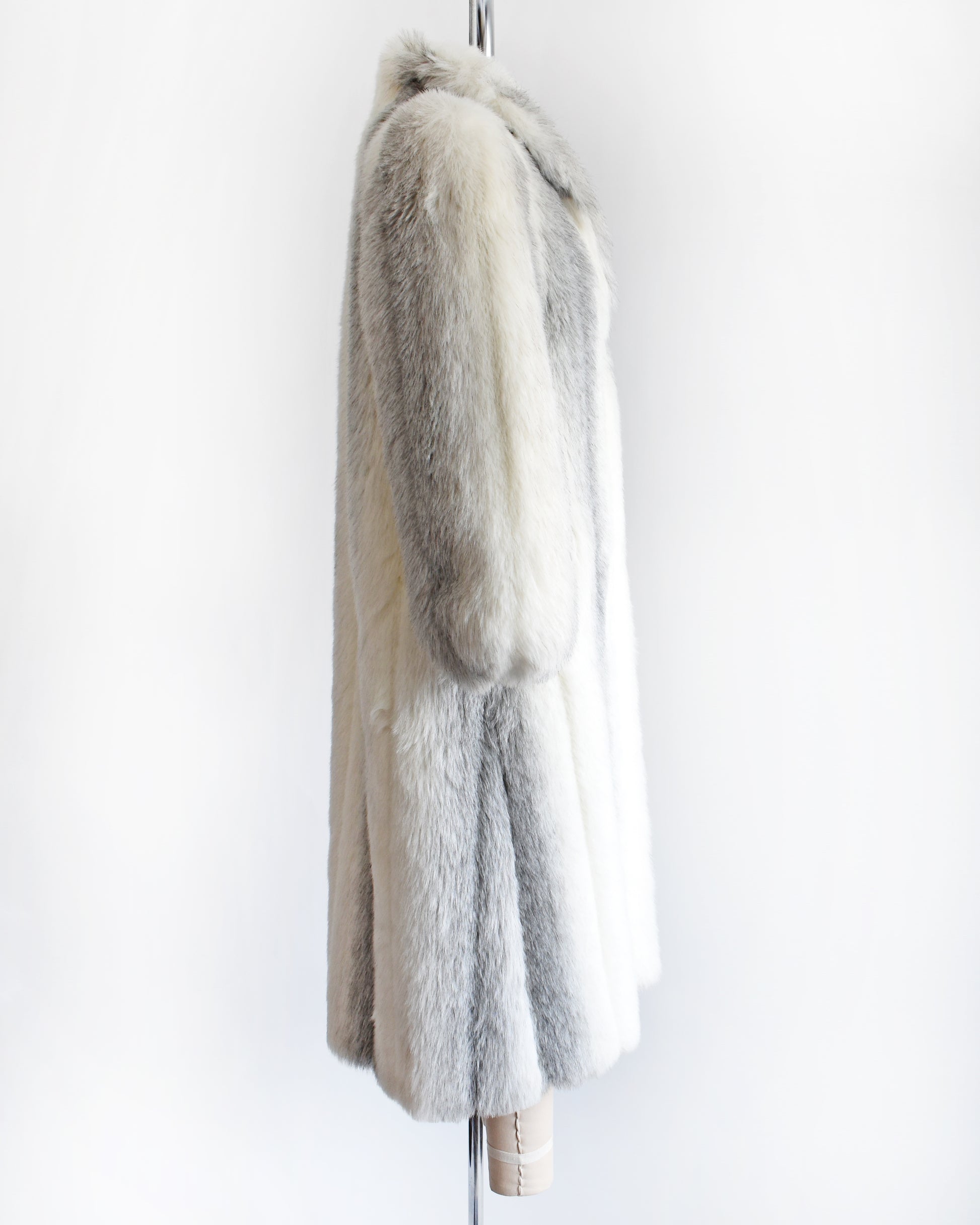 side view of a vintage 1980s faux fur coat on a mannequin against a white background