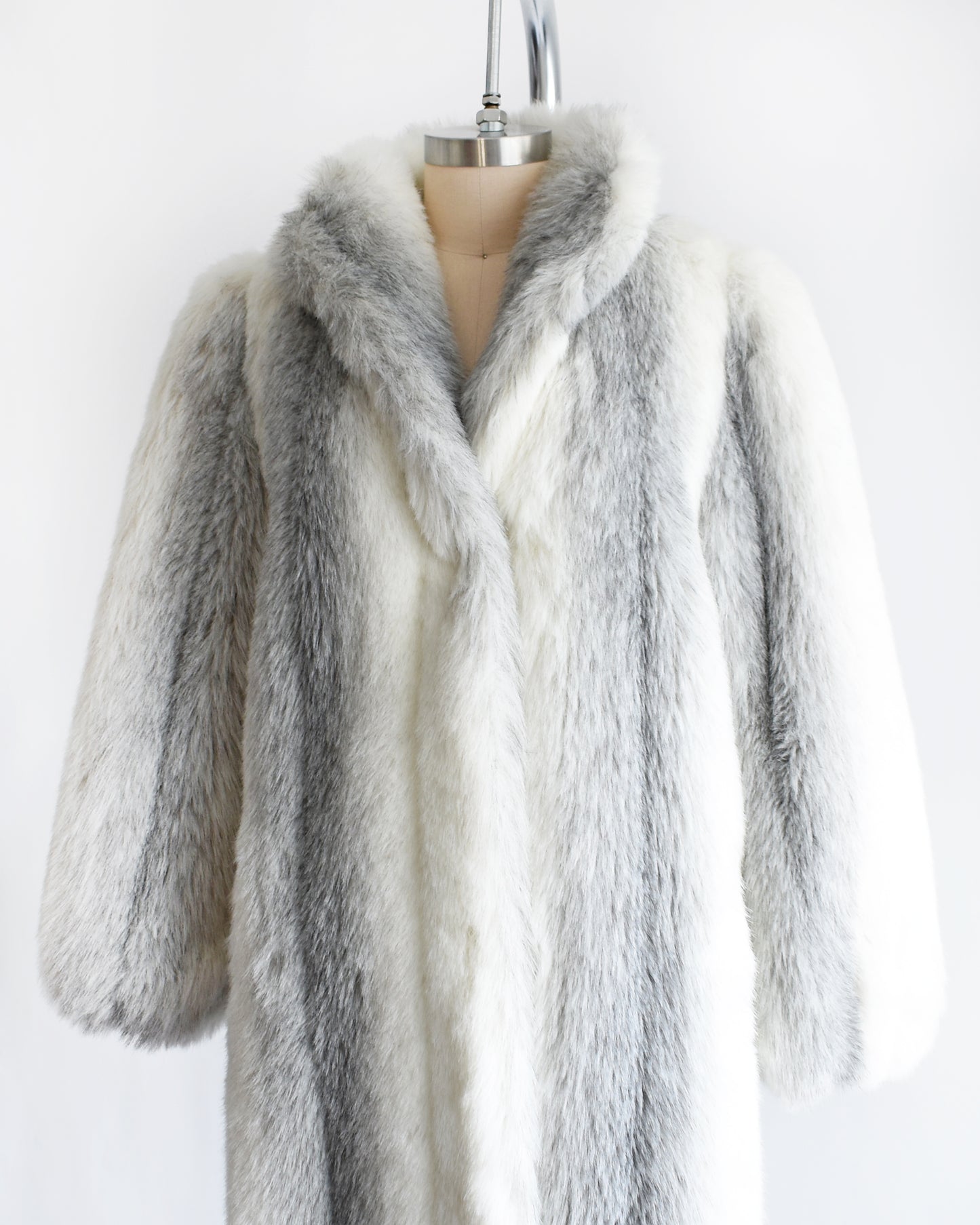 side front view of a vintage 1980s faux fur coat on a mannequin against a white background