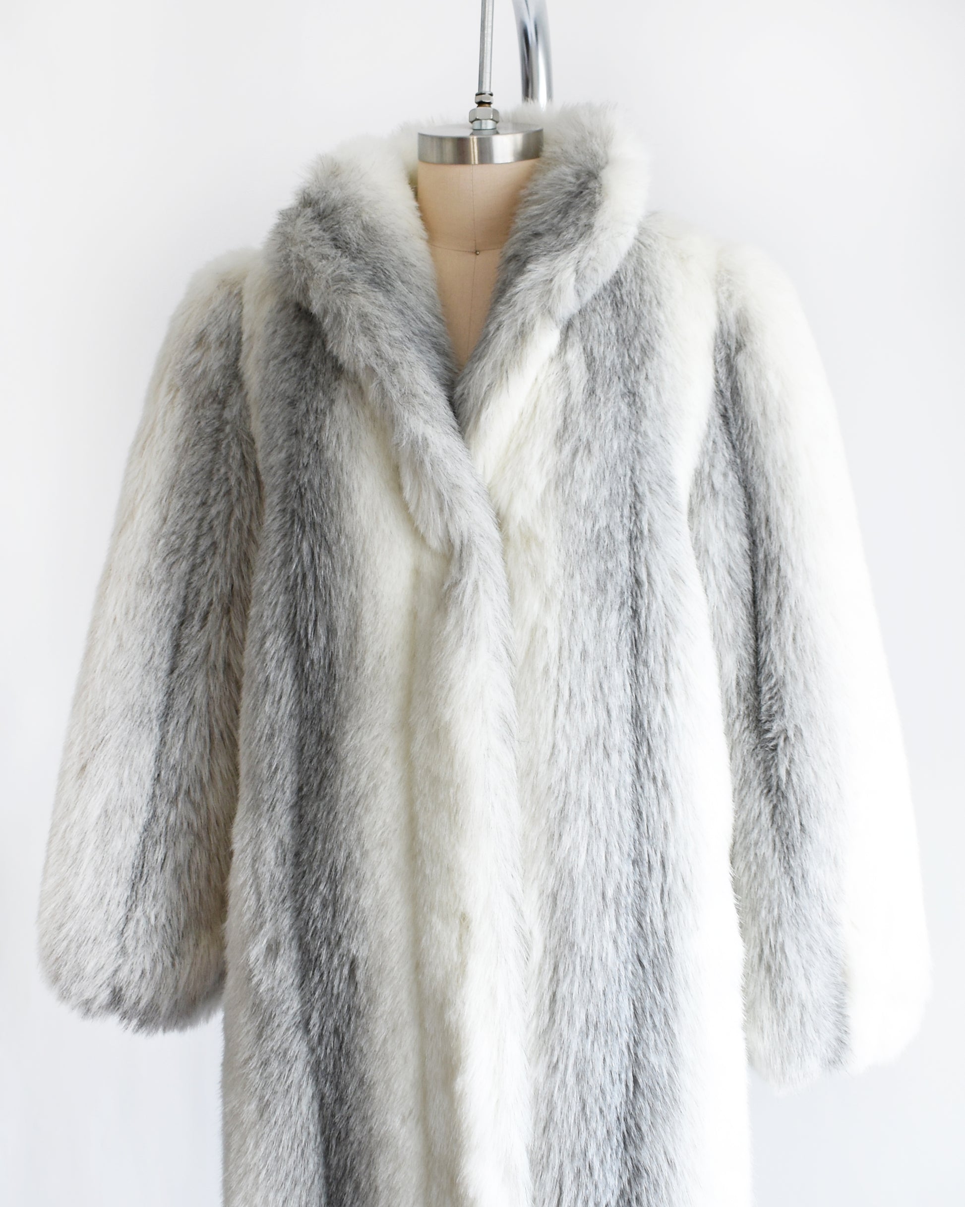 side front view of a vintage 1980s faux fur coat on a mannequin against a white background