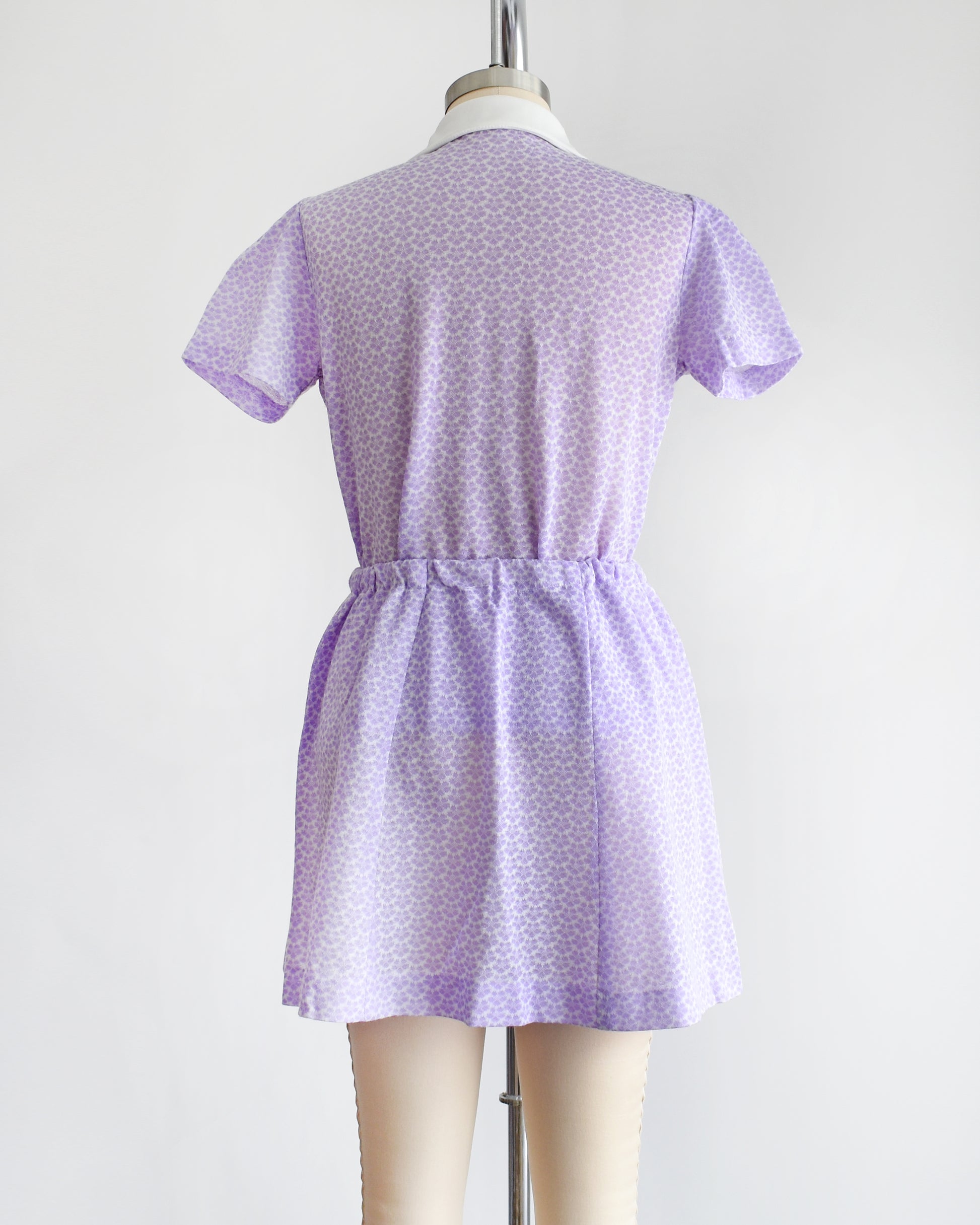 back view of a vintage 1970s mod floral purple blouse and skirt set